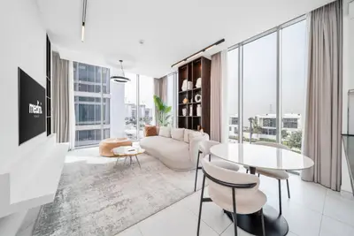 Open living and dining area with floor-to-ceiling windows and round dining table