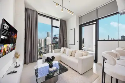 Living room with sectional sofa, marble coffee table and city skyline views