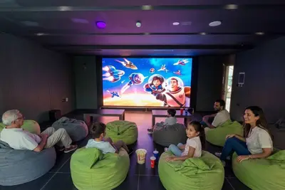 Cinema room with a large screen and rows of bean-bag seats