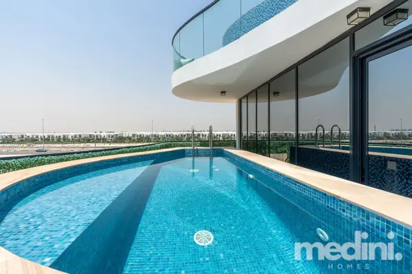 Private rooftop pool with blue mosaic tiles and open-air views beyond the balcony railing