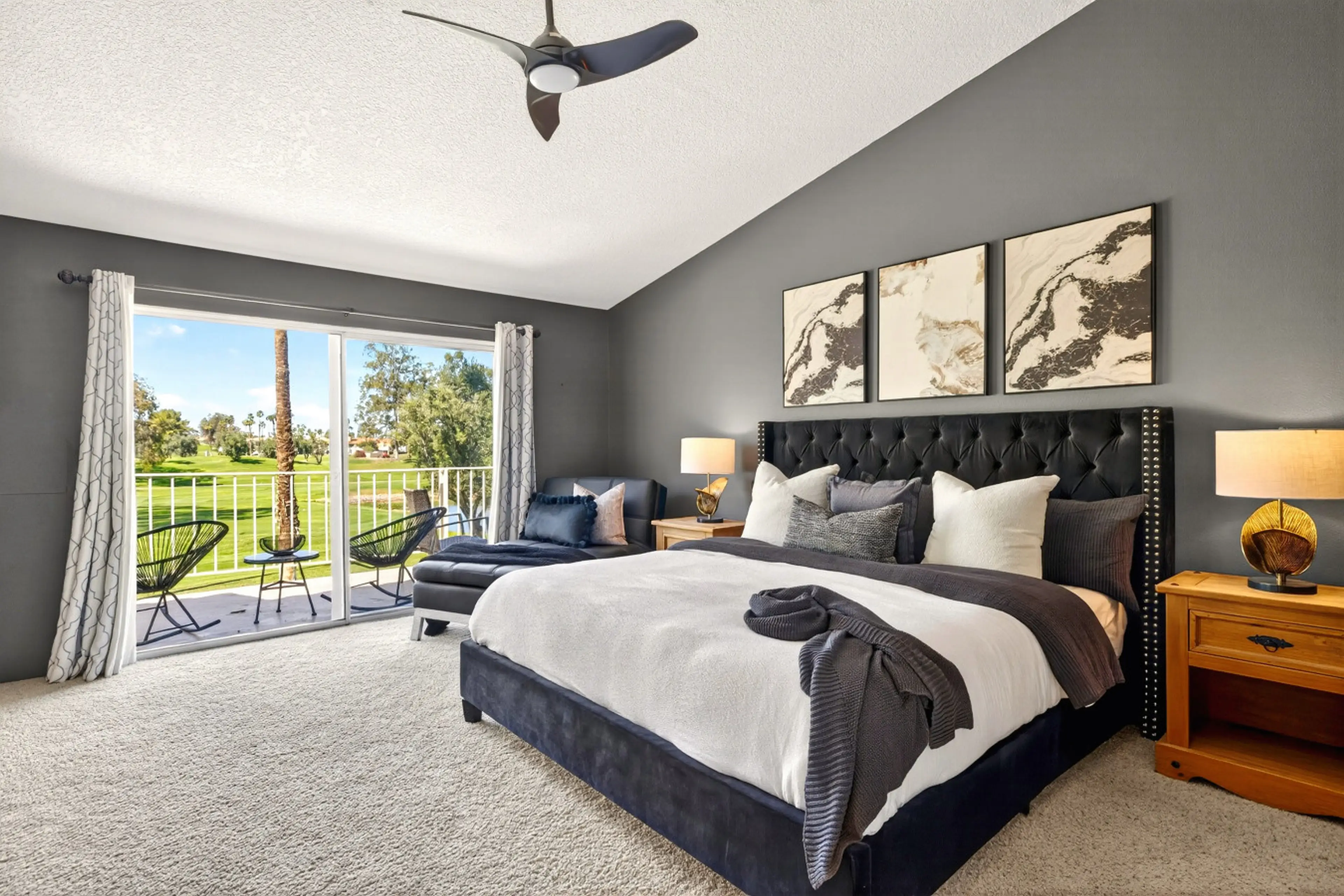 Primary bedroom with king bed, large TV, and serene fairway-views