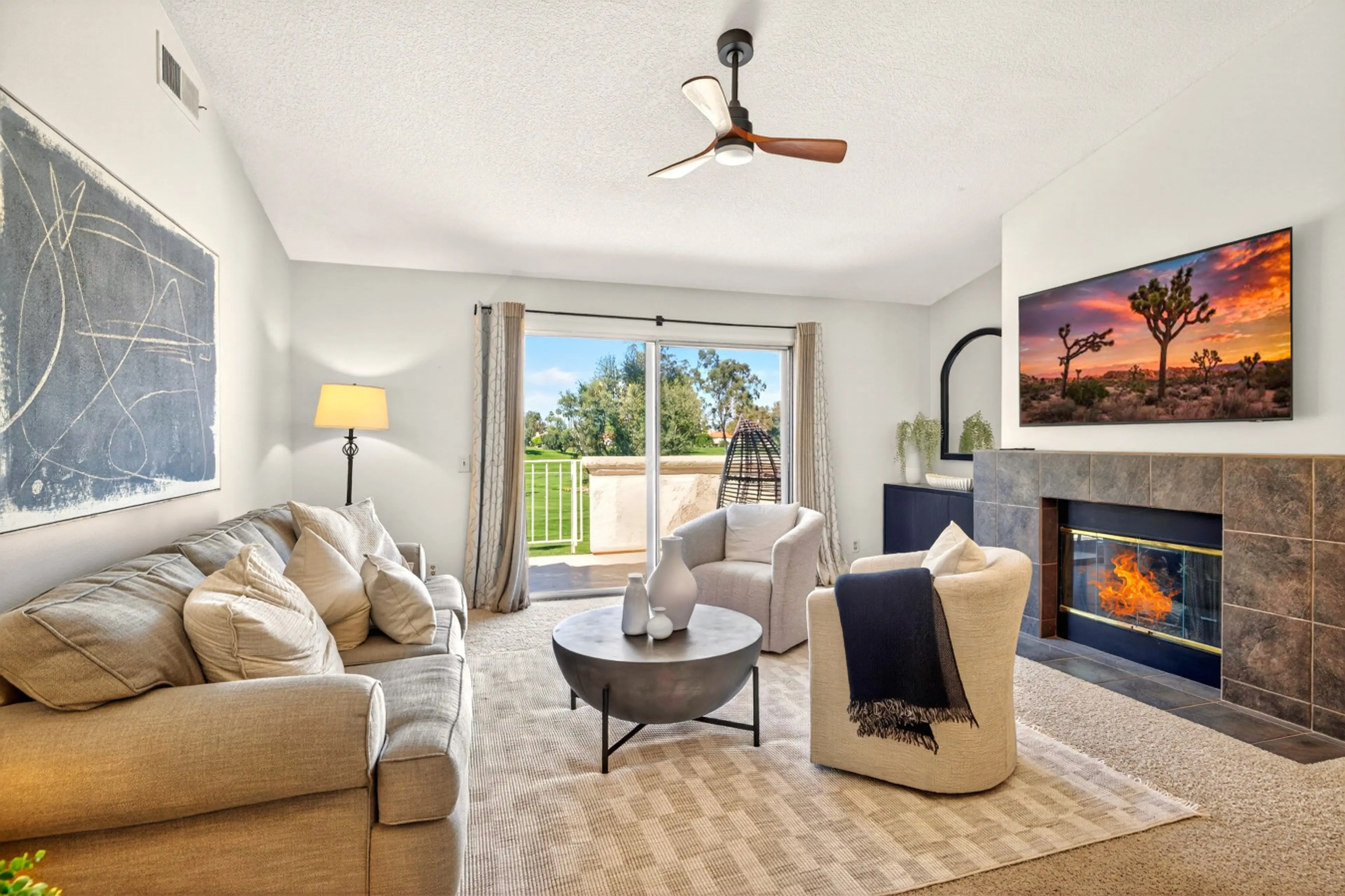 Spacious living room with plush sofa, fireplace, and large smart TV for relaxing nights in