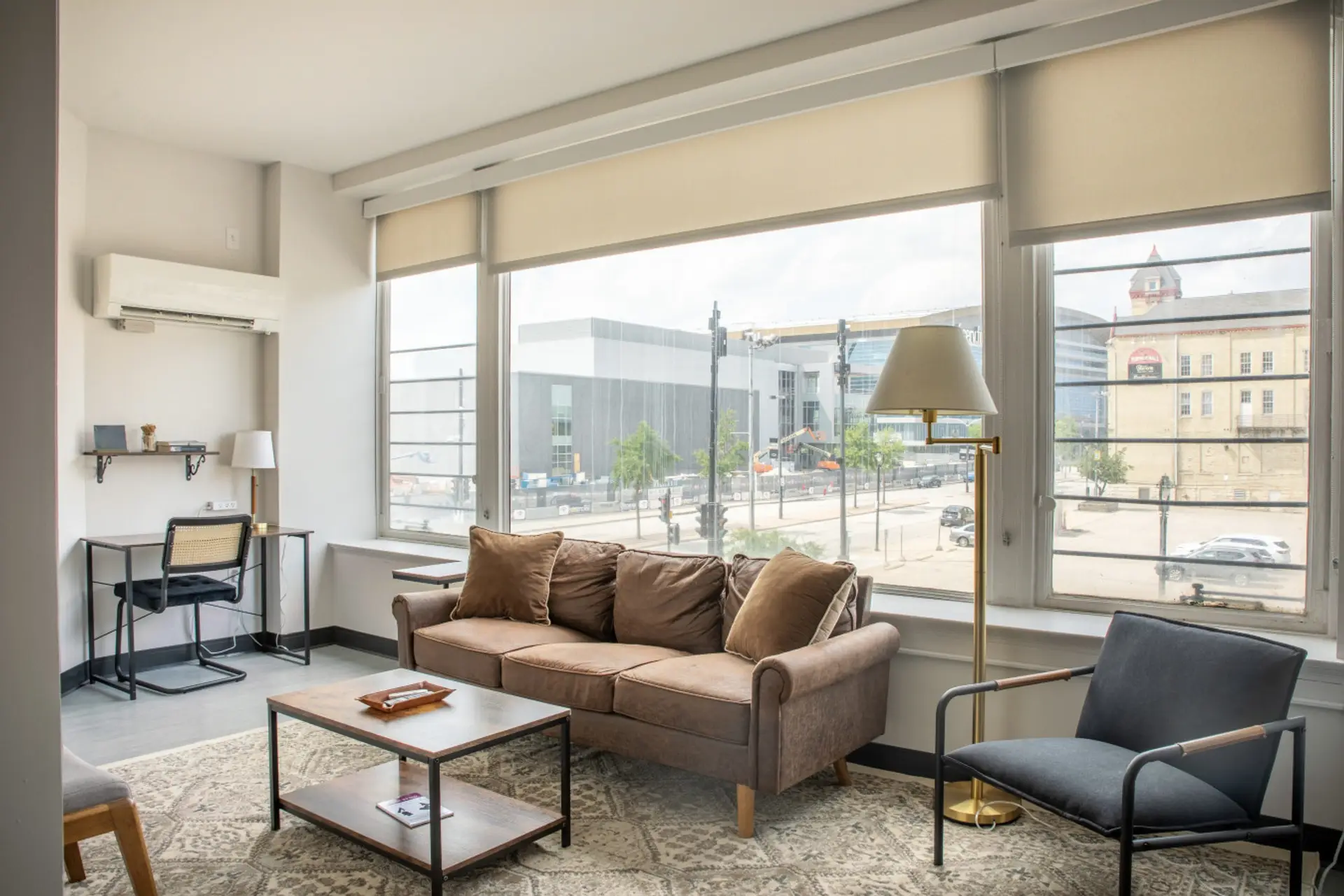 Sun-drenched living area featuring charming architecture and a front-row view of the Fiserv Forum.