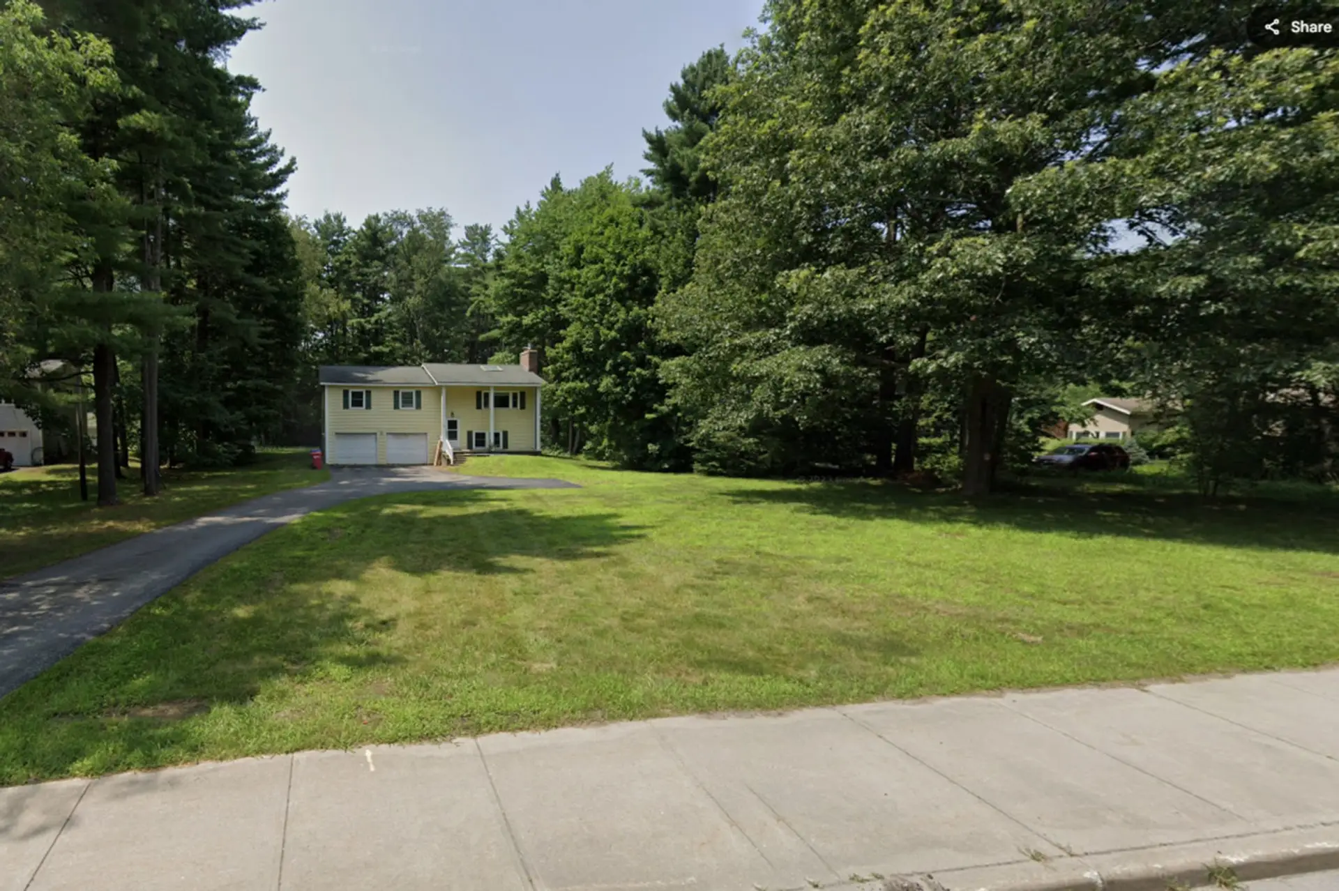 Exterior of house far setback with large lawn and backyard