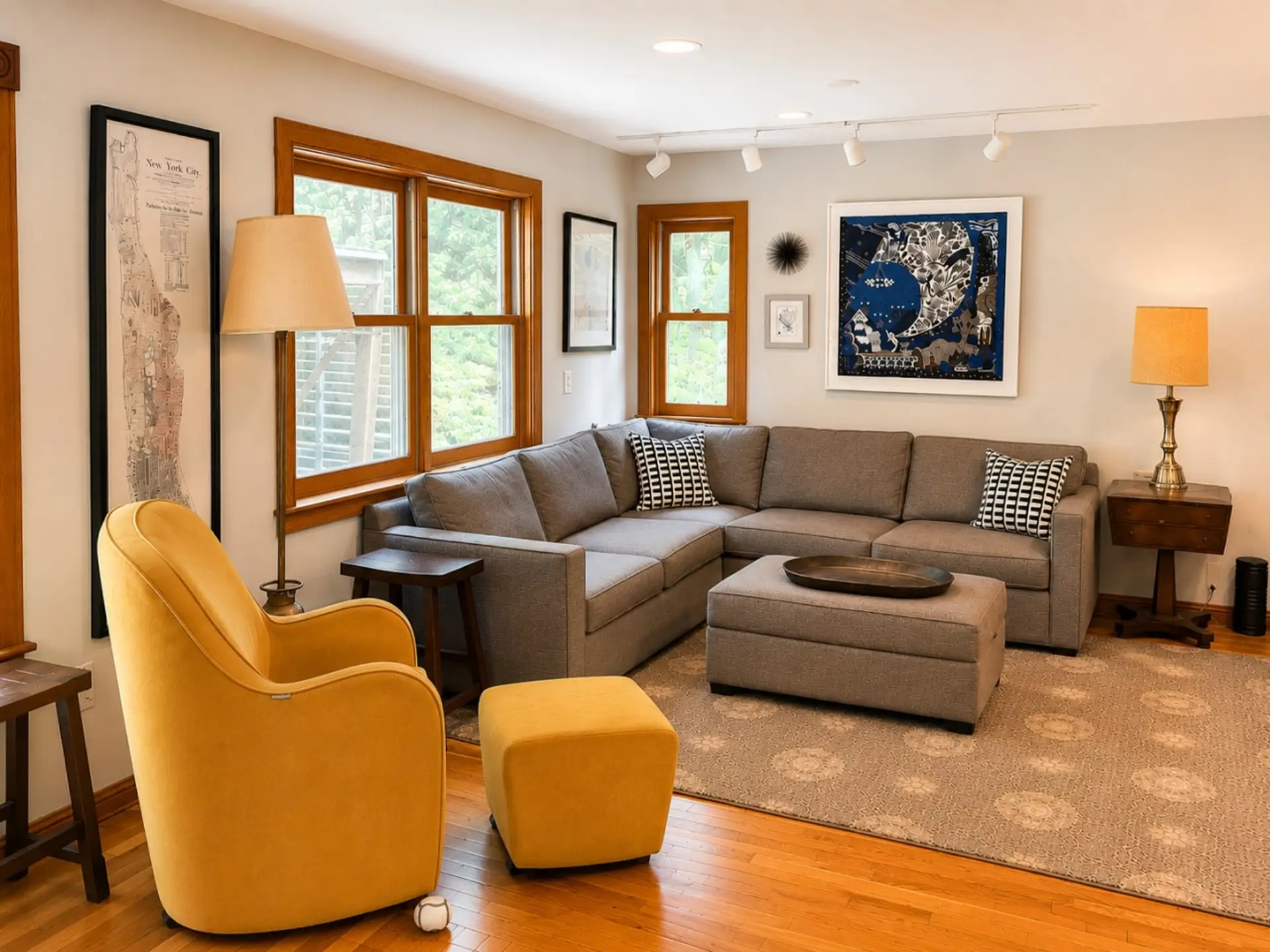 Relax in the cozy living room, featuring comfortable seating, warm natural light, and peaceful views of the surrounding woods.
