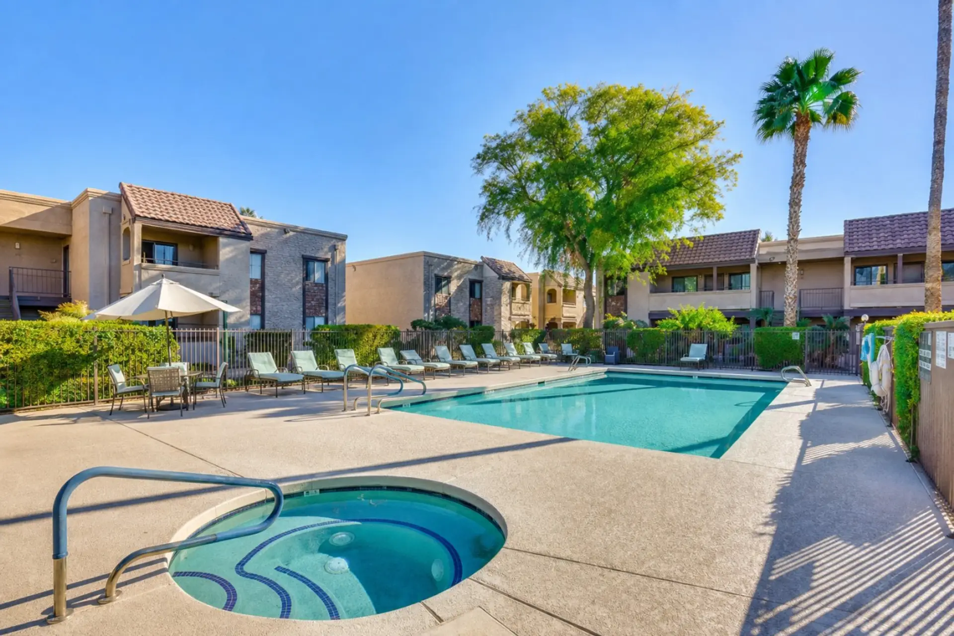 Shared community pool and spa area with lounge seating, sunny patio space, and room to unwind outdoors.