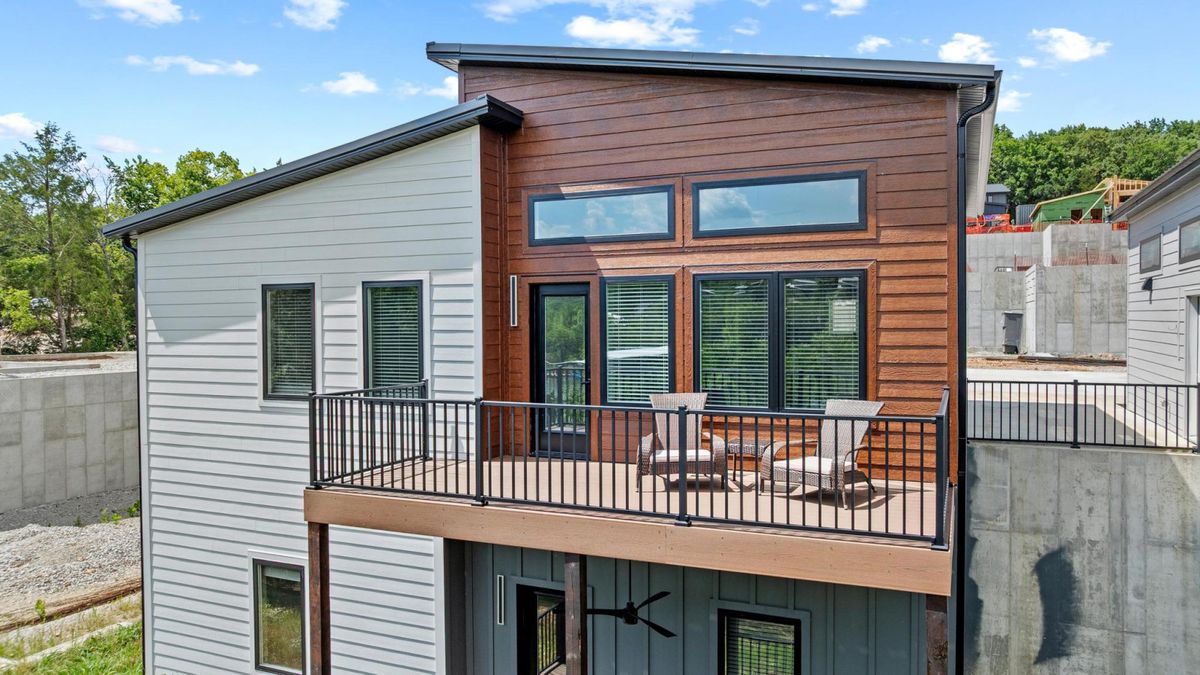 Modern lakefront home with a cedar-clad deck in Reeds Spring
