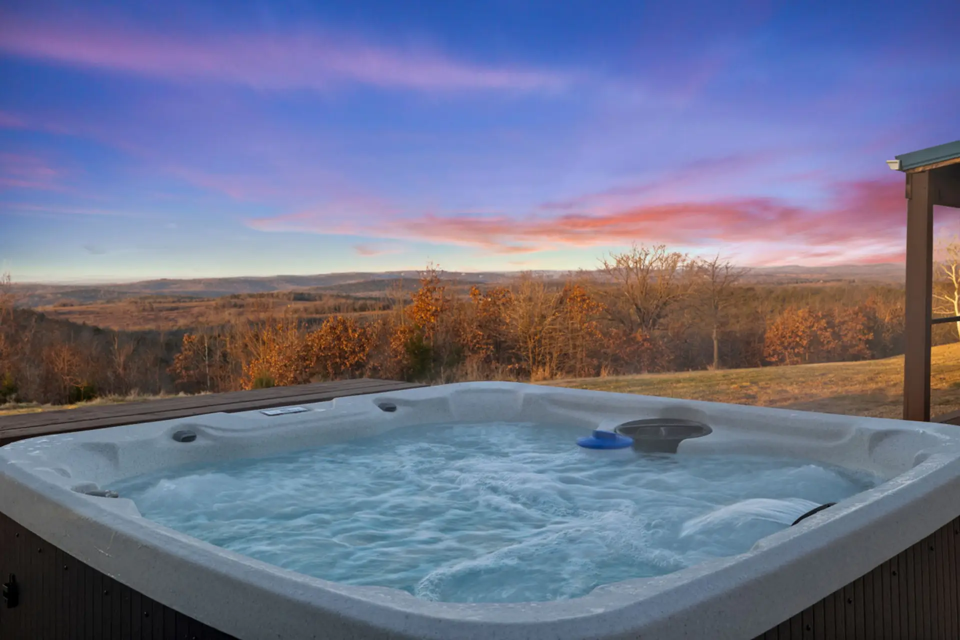Private hot tub with panoramic sunset views.