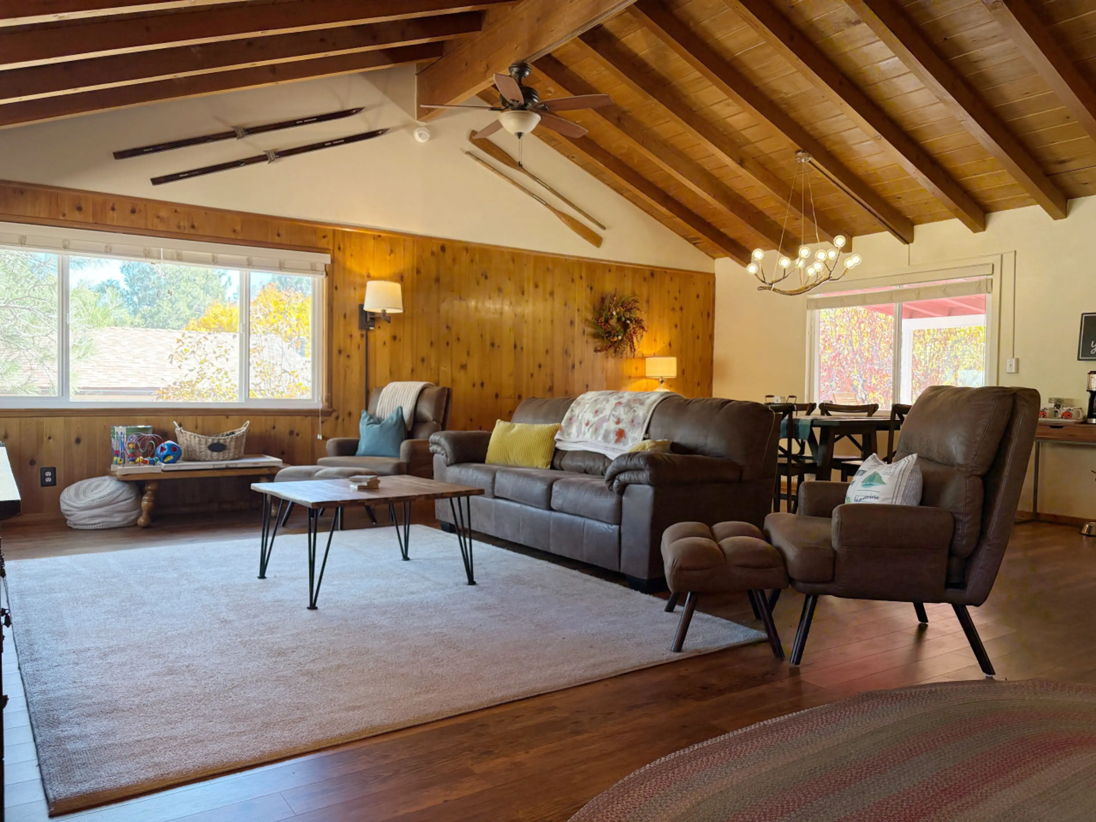 Cozy living room with leather sofas, wood-paneled walls