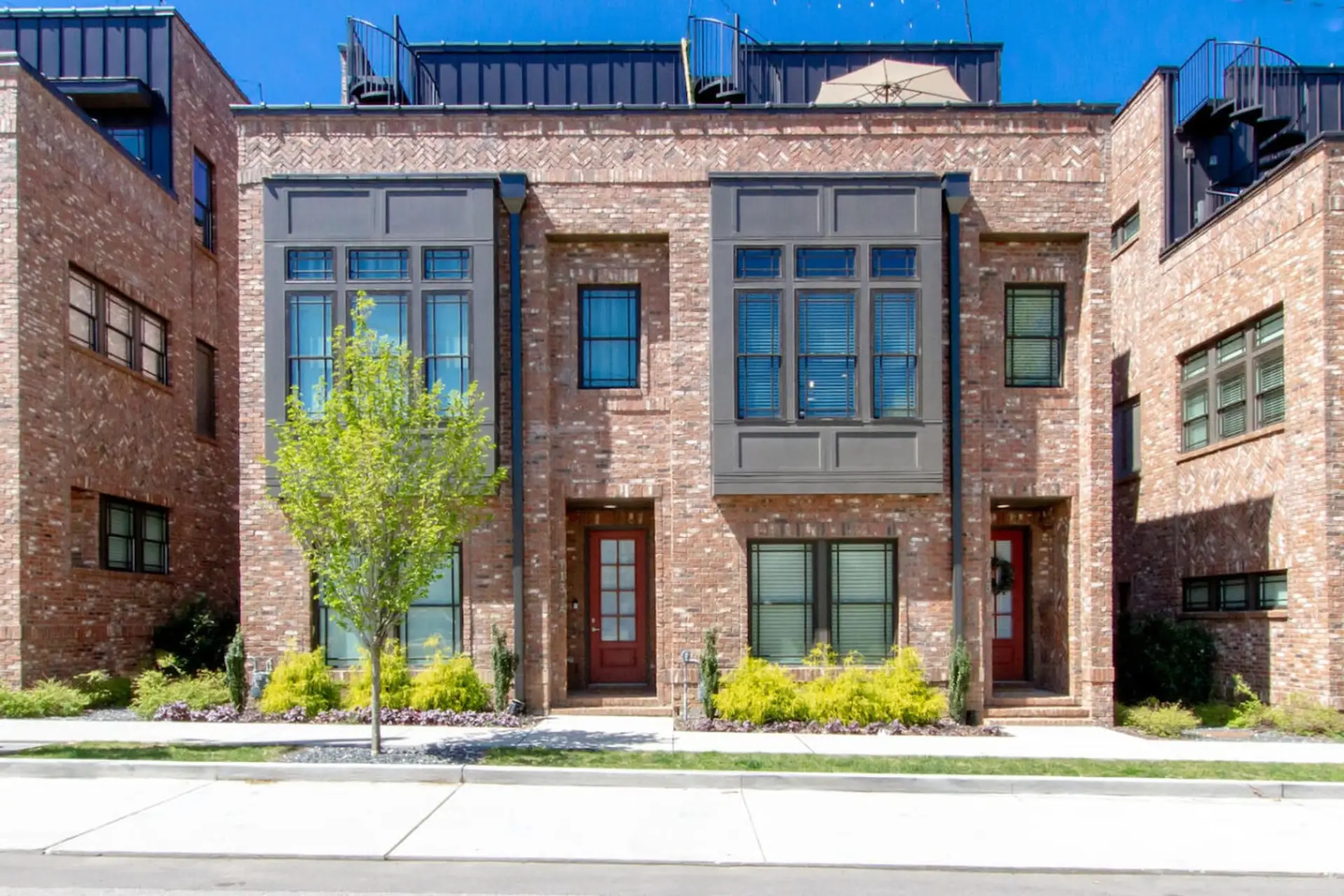 Stylish two-story brick townhome with welcoming curb appeal