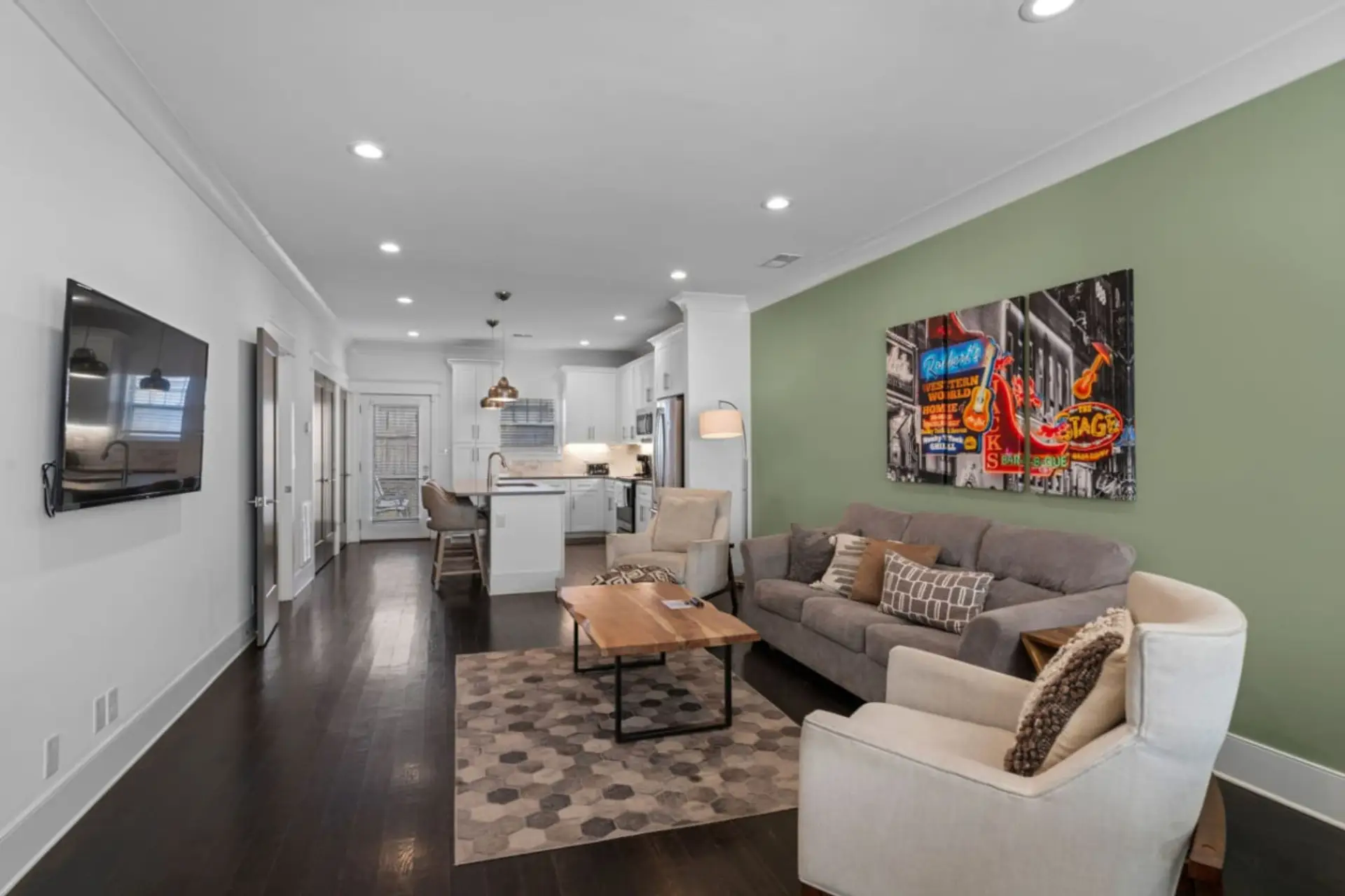 Open-concept living room with a sectional sofa and wall-mounted TV
