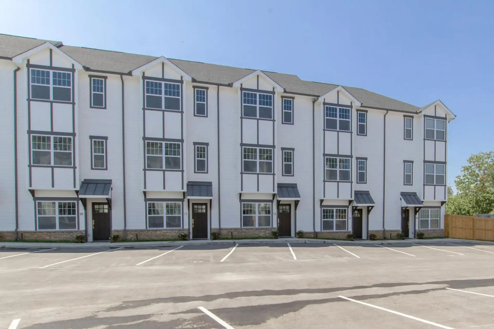 Exterior view of the multi-story townhome community with on-site parking