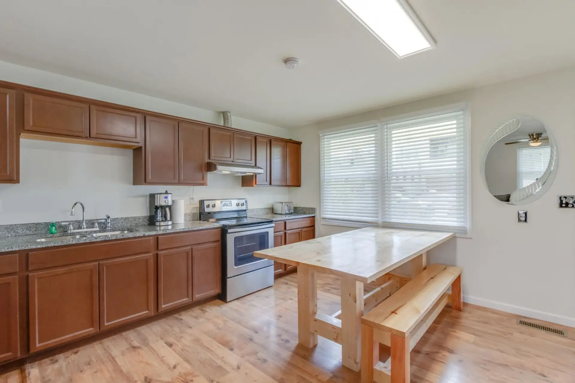 The kitchen features warm wood cabinets, a center island, and all the appliances for a comfortable stay.