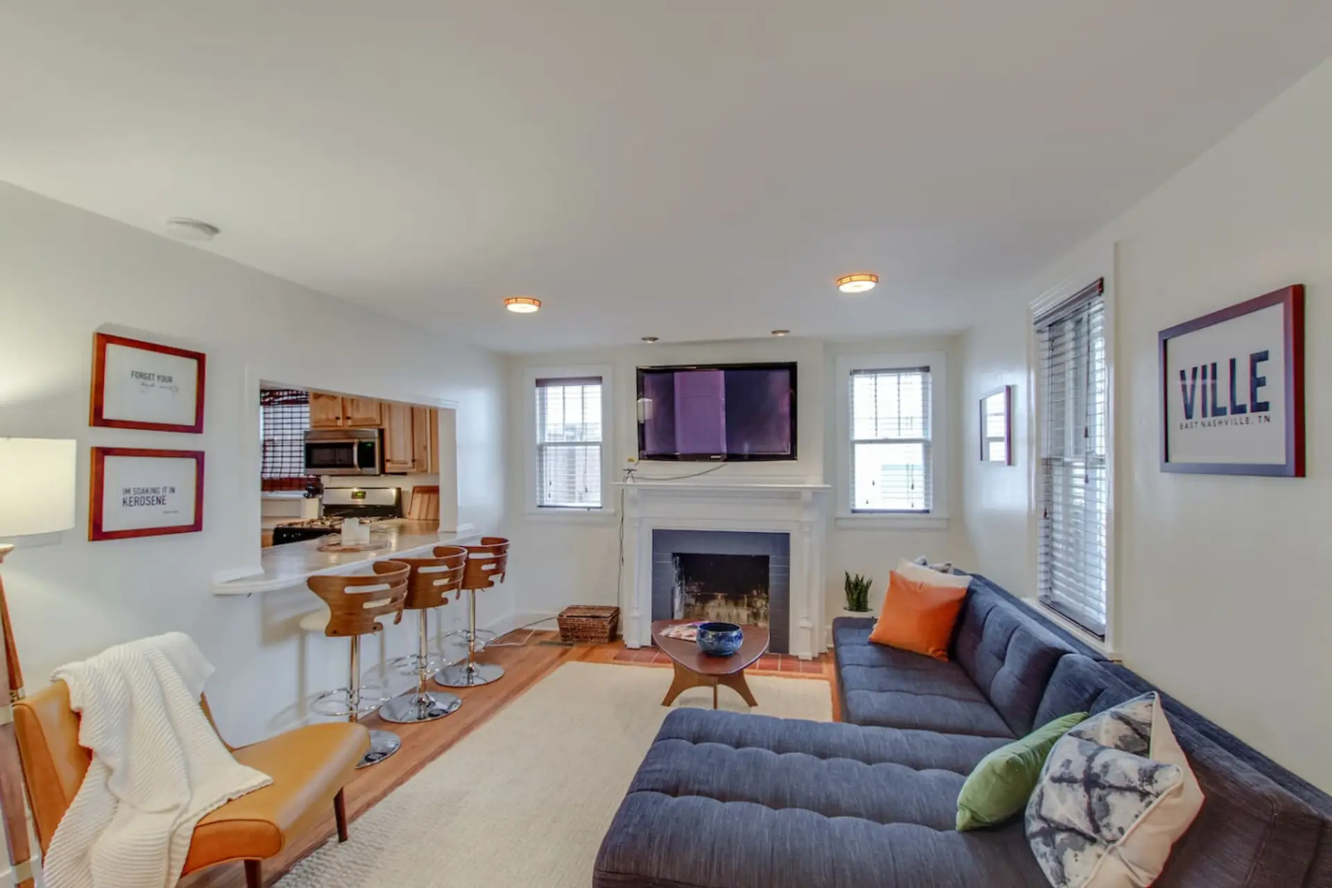 Settle in around the large flat-screen TV in the bright, Nashville-inspired living room.