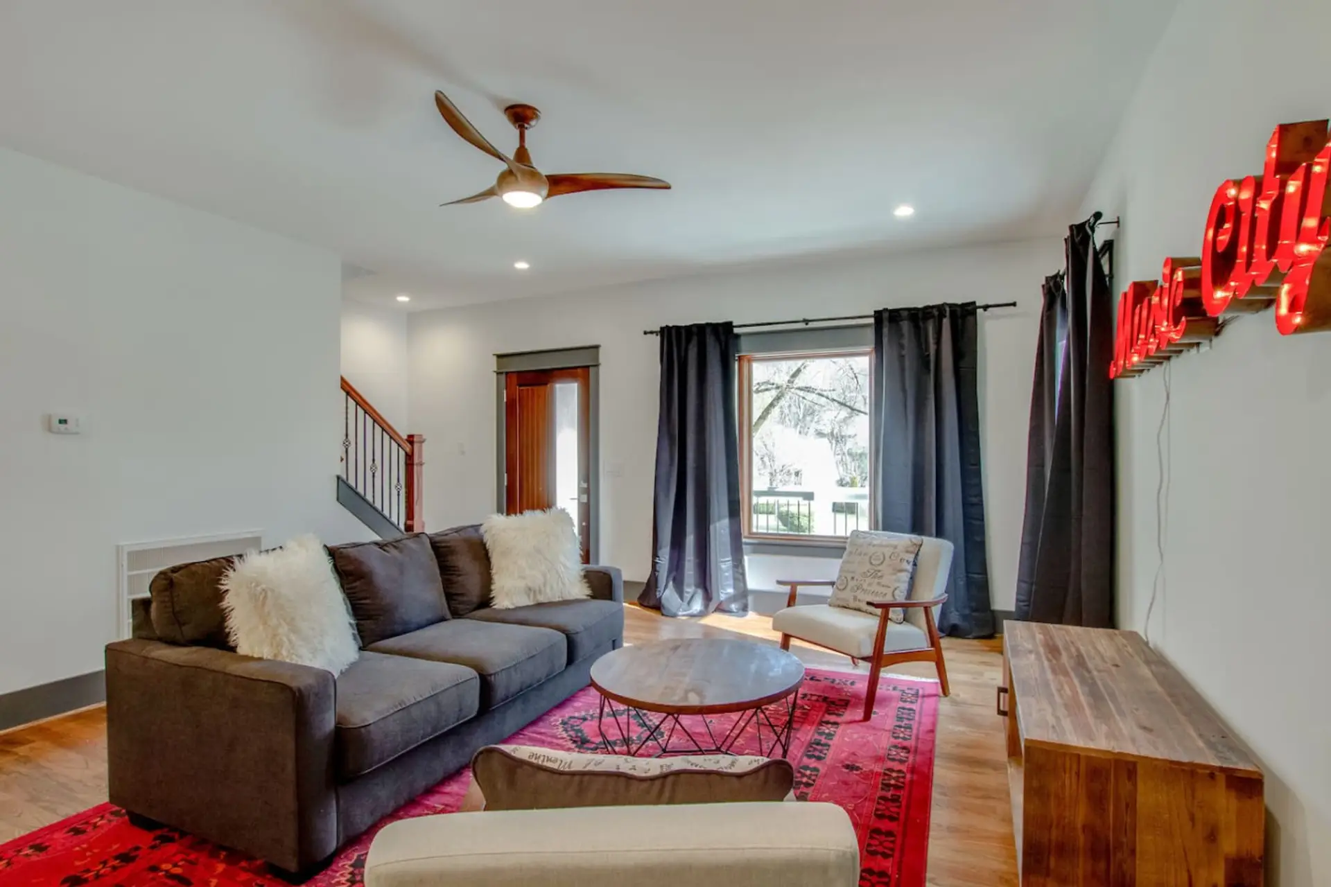 Sunlit living room with sectional seating, professionally maintained by Host Extraordinaires