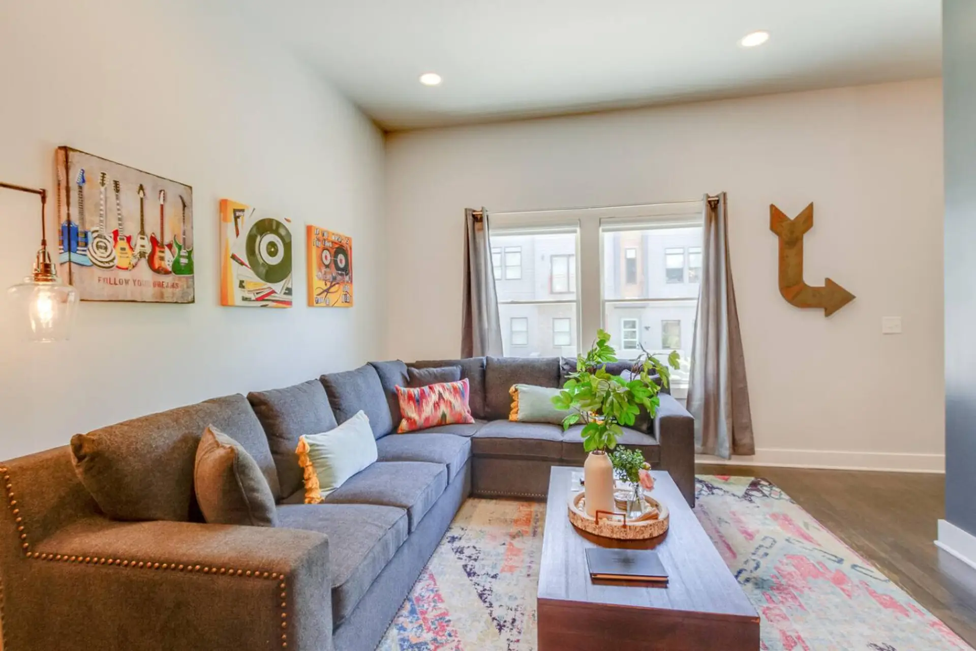 A cozy haven for relaxation with a comfortable sectional and eclectic, artful decor