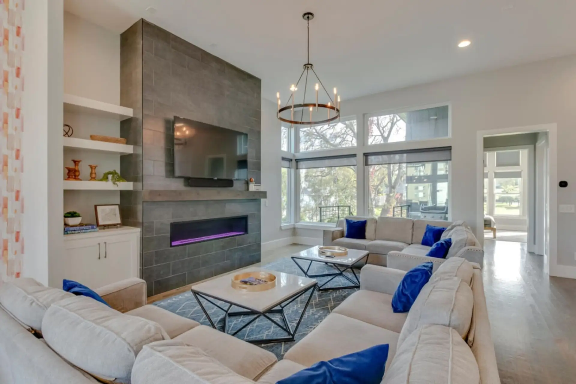 Gather around the fireplace in this bright, spacious living room made for relaxing together.