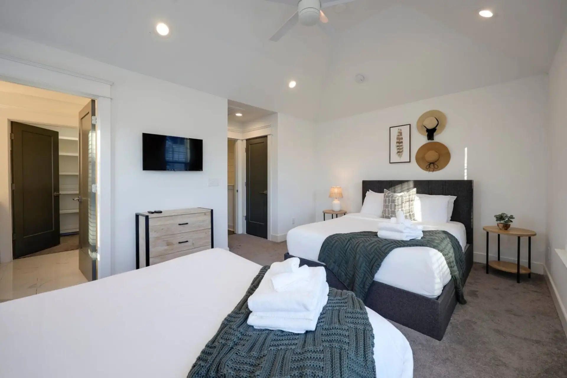 Bedroom with mounted TV and closet