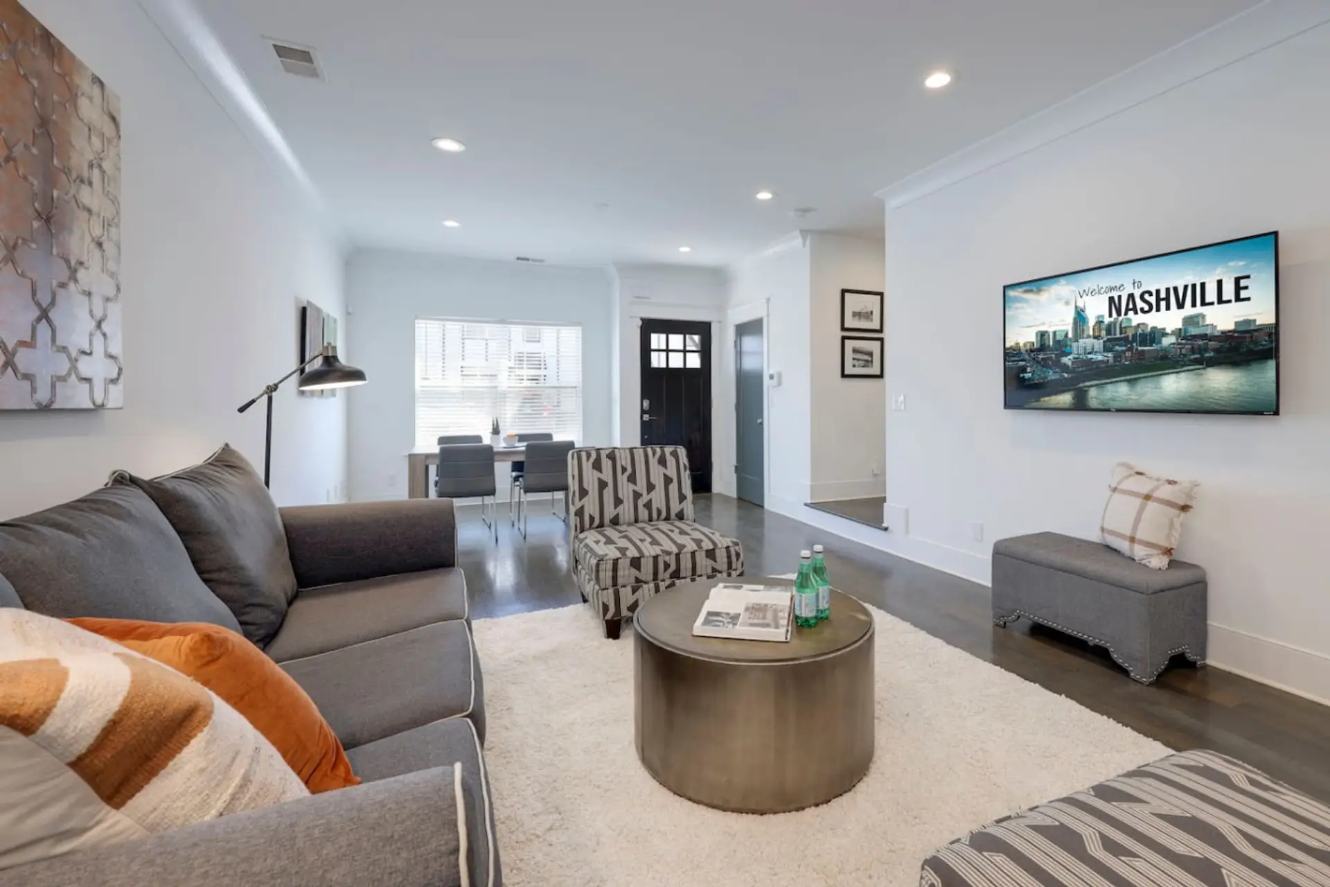 Bright open-concept living room with comfortable seating and a smart TV
