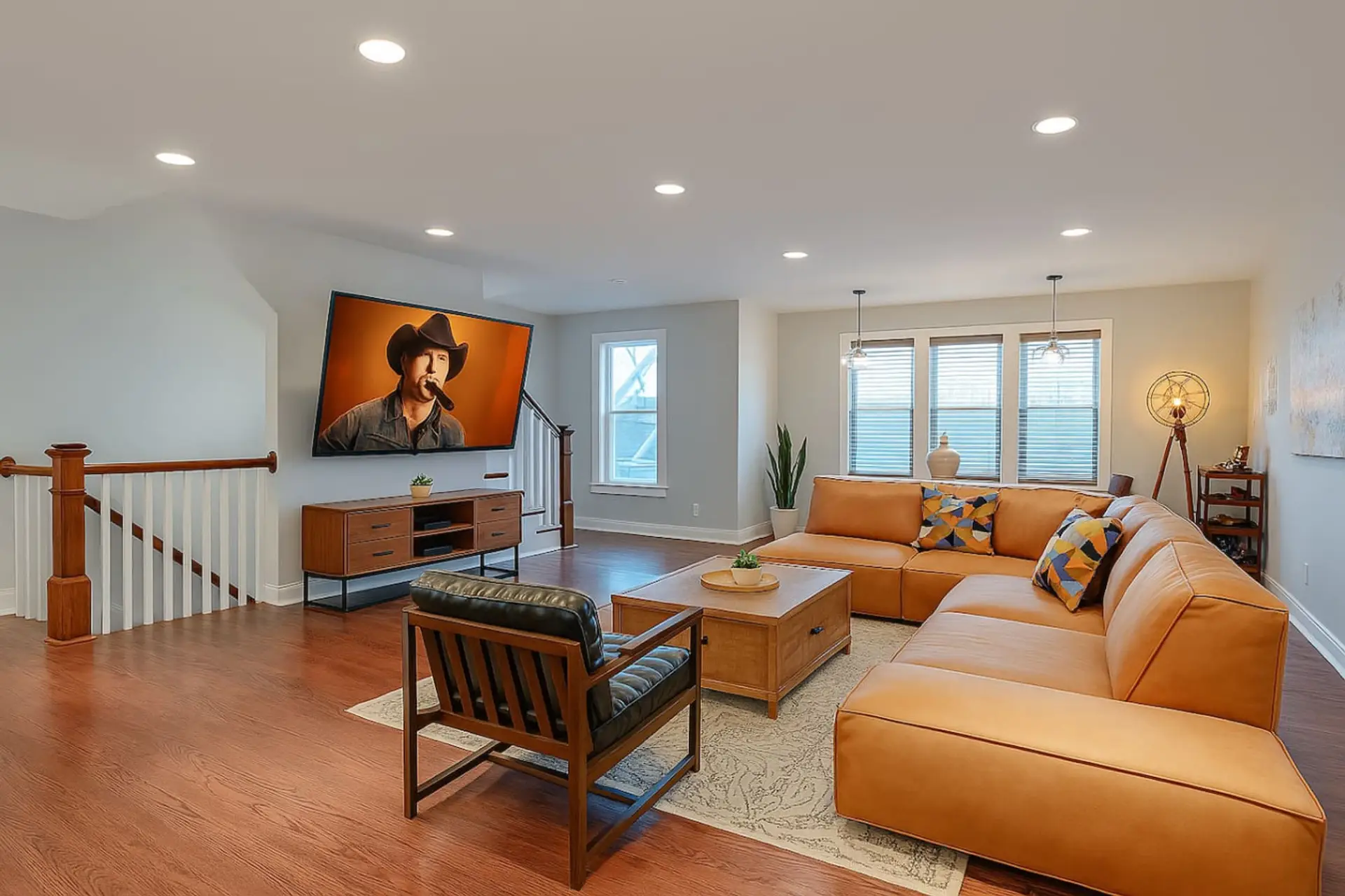 Comfortable living room with leather seating and a wall-mounted TV