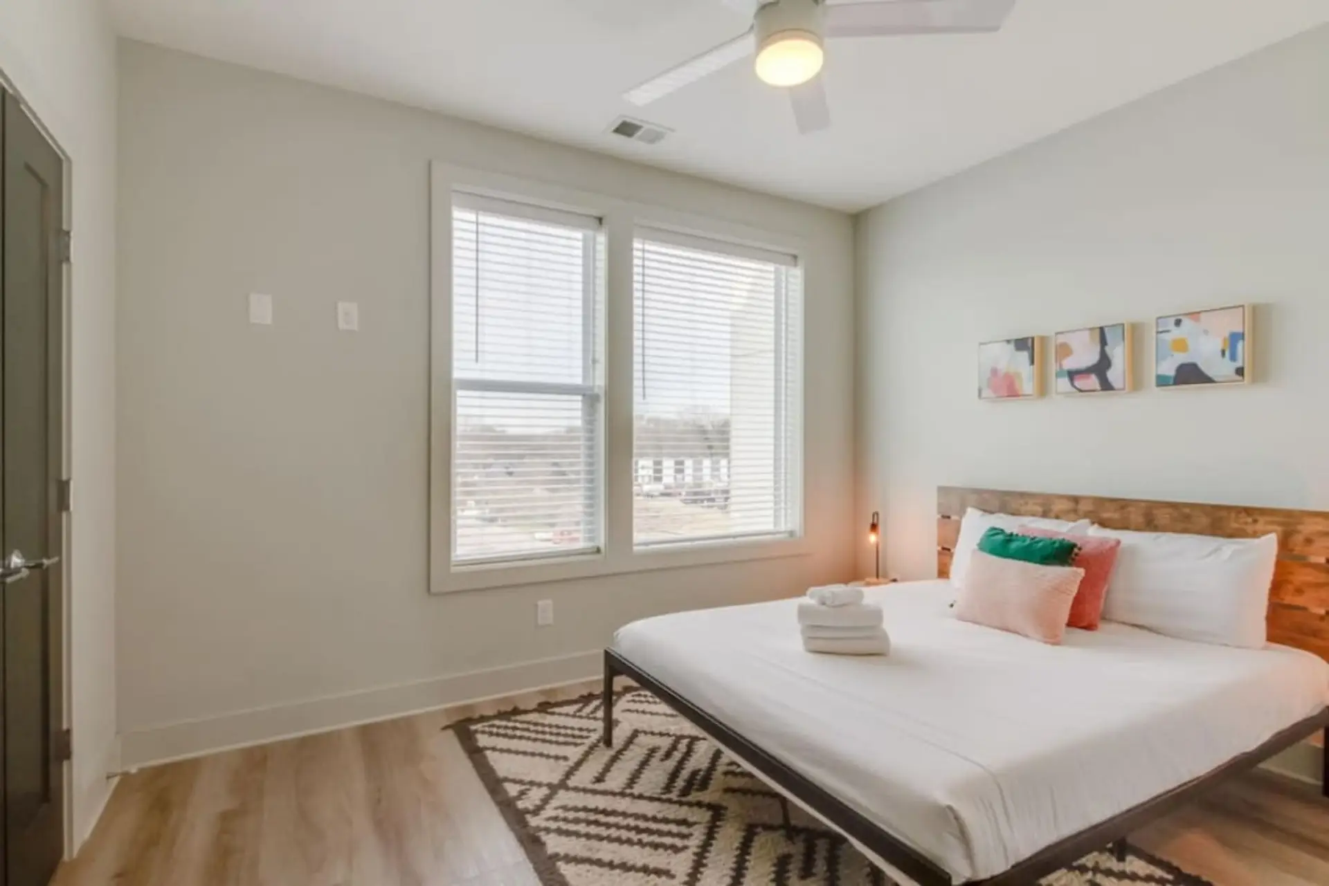 A fresh and well-lit bedroom with clean linens and a modern design offers a great night's rest.