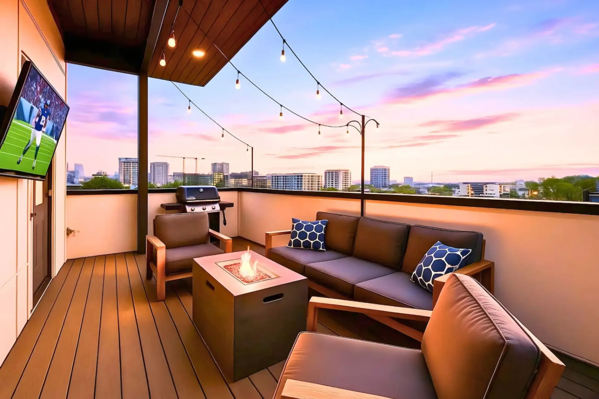 The rooftop terrace glows at golden hour with Nashville city views and plush outdoor seating.