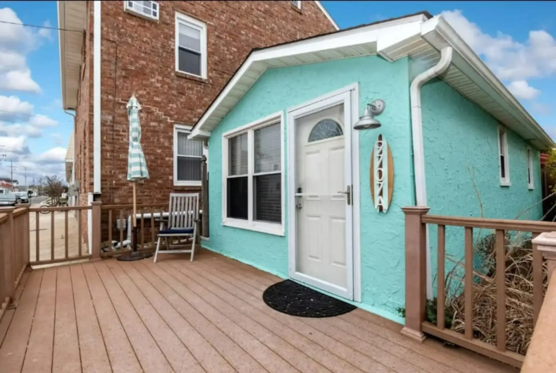 Charming coastal exterior with private fenced patio space