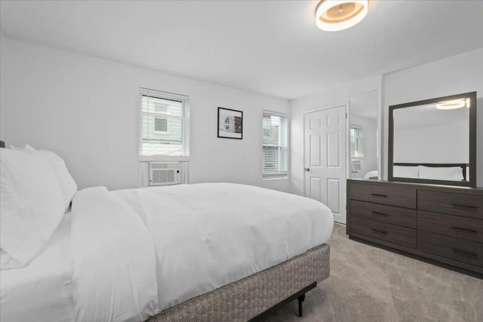 Queen bedroom with blackout window coverings and closet storage