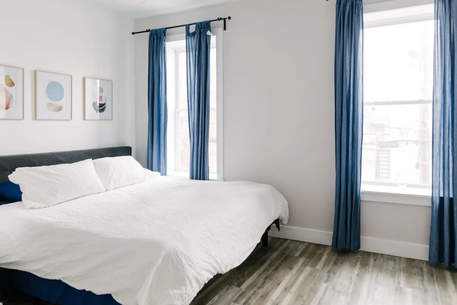 The main bedroom is a king sized bed and the windows overlook the front street.