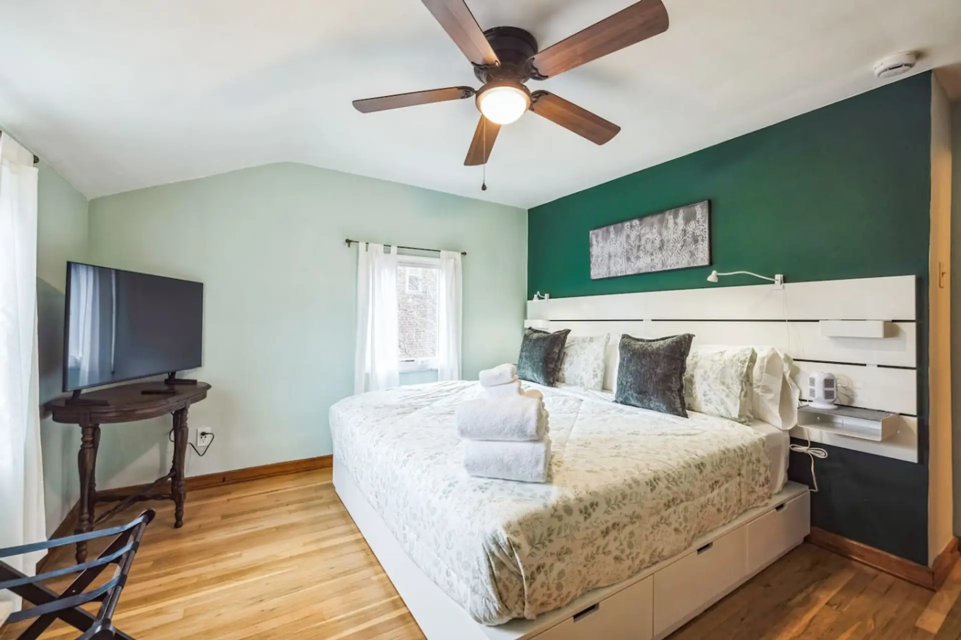 Relax in comfort in this bright and airy bedroom featuring a plush king bed