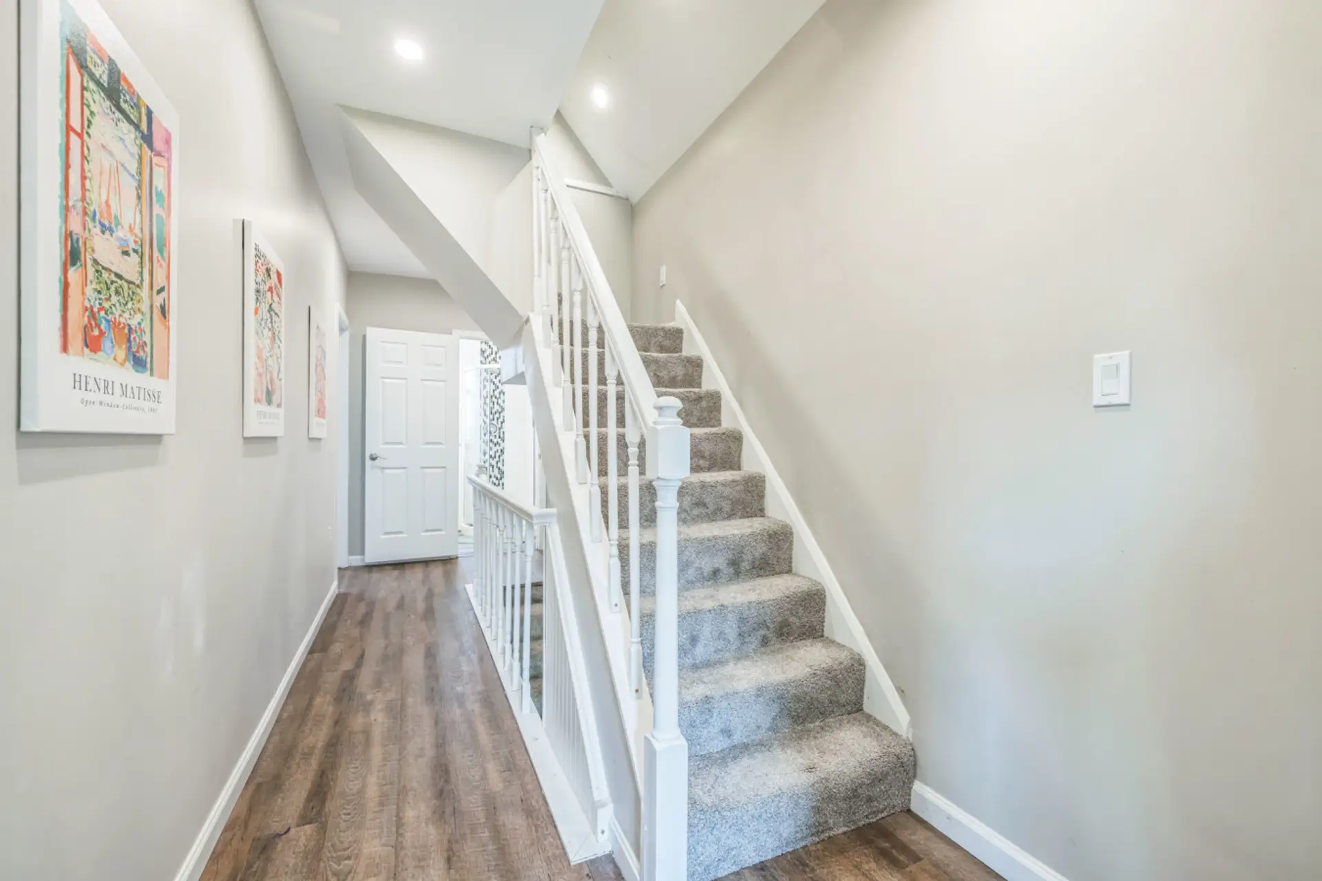 Elegant staircase and hallway connecting the home’s inviting spaces