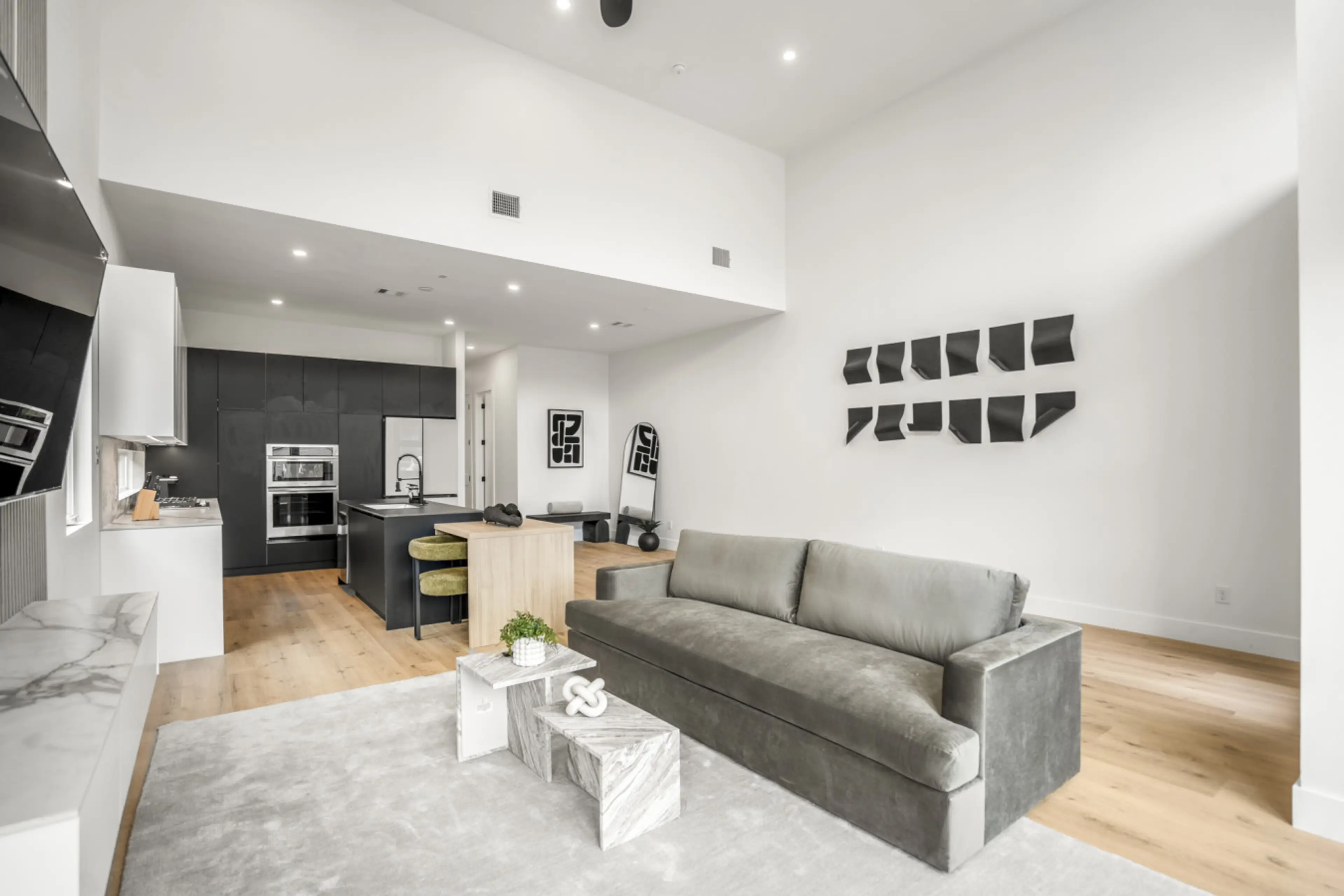 A modern, open-concept space with sleek finishes, artistic decor, and a bright, airy vibe.