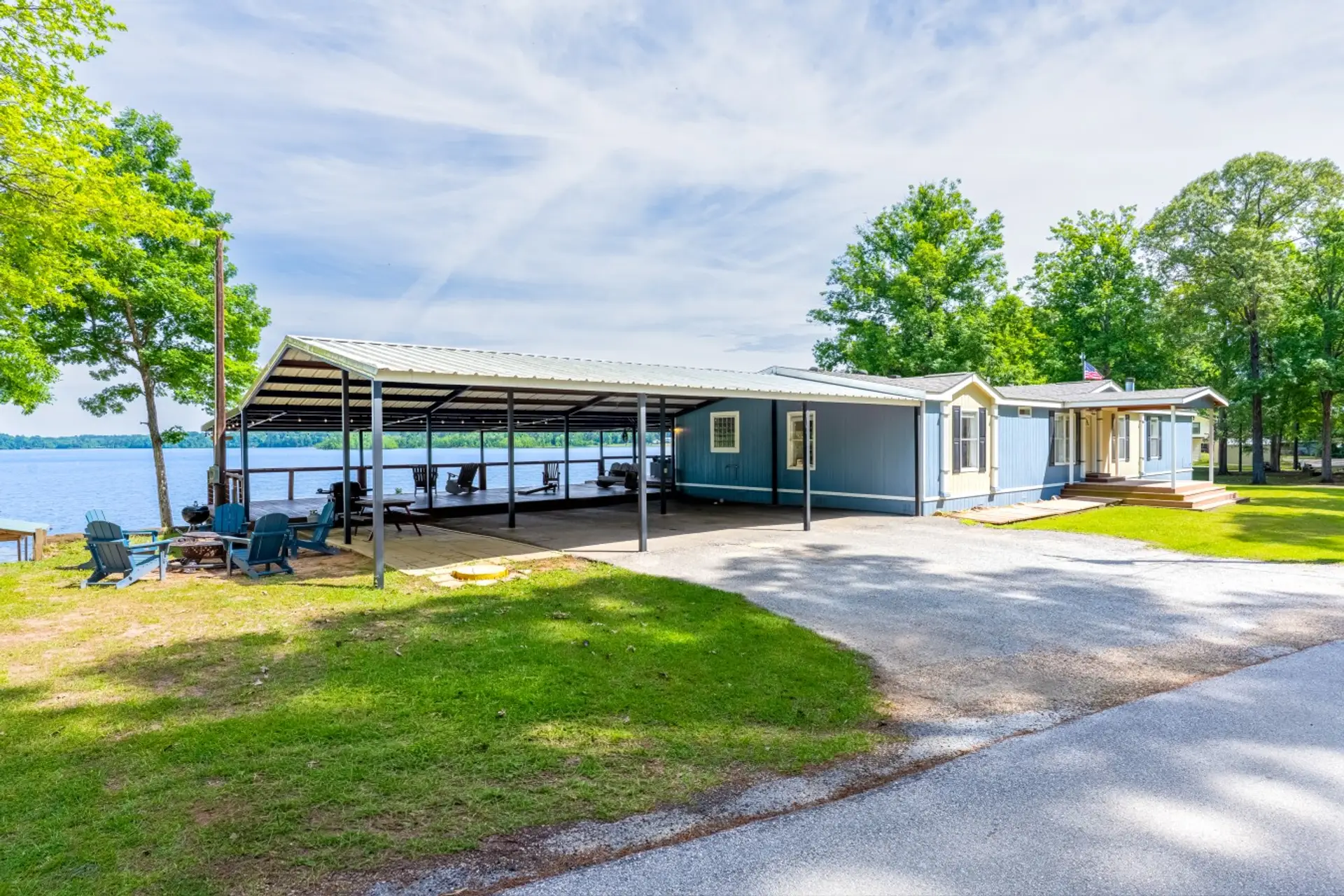 Front of House with carport, deck and chairs