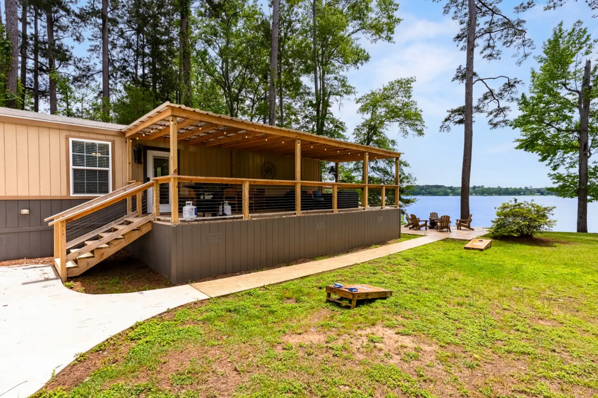 Right on the water Covered deck, patio, & cornhole!