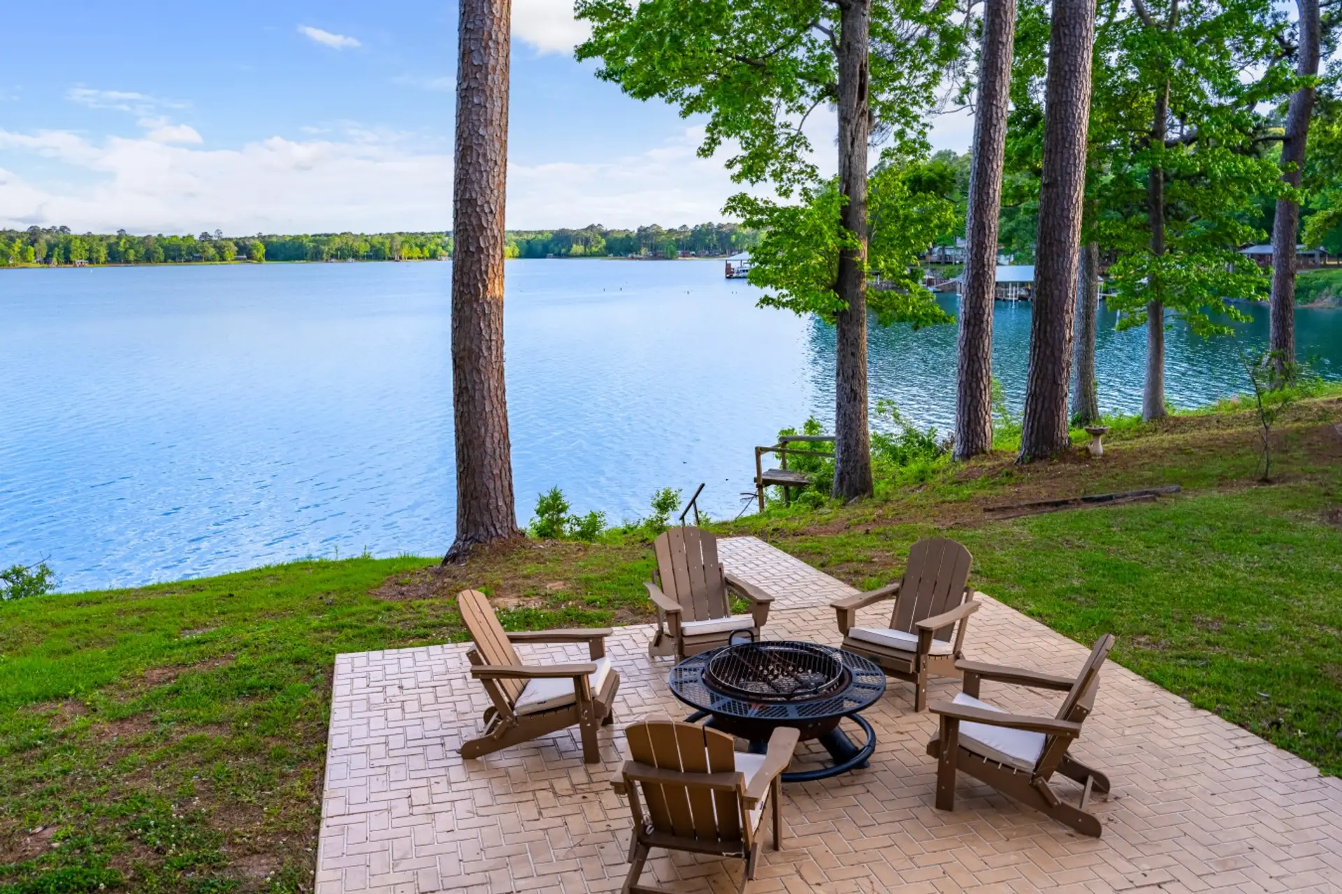 Chairs around the firepit overlooking serene waters