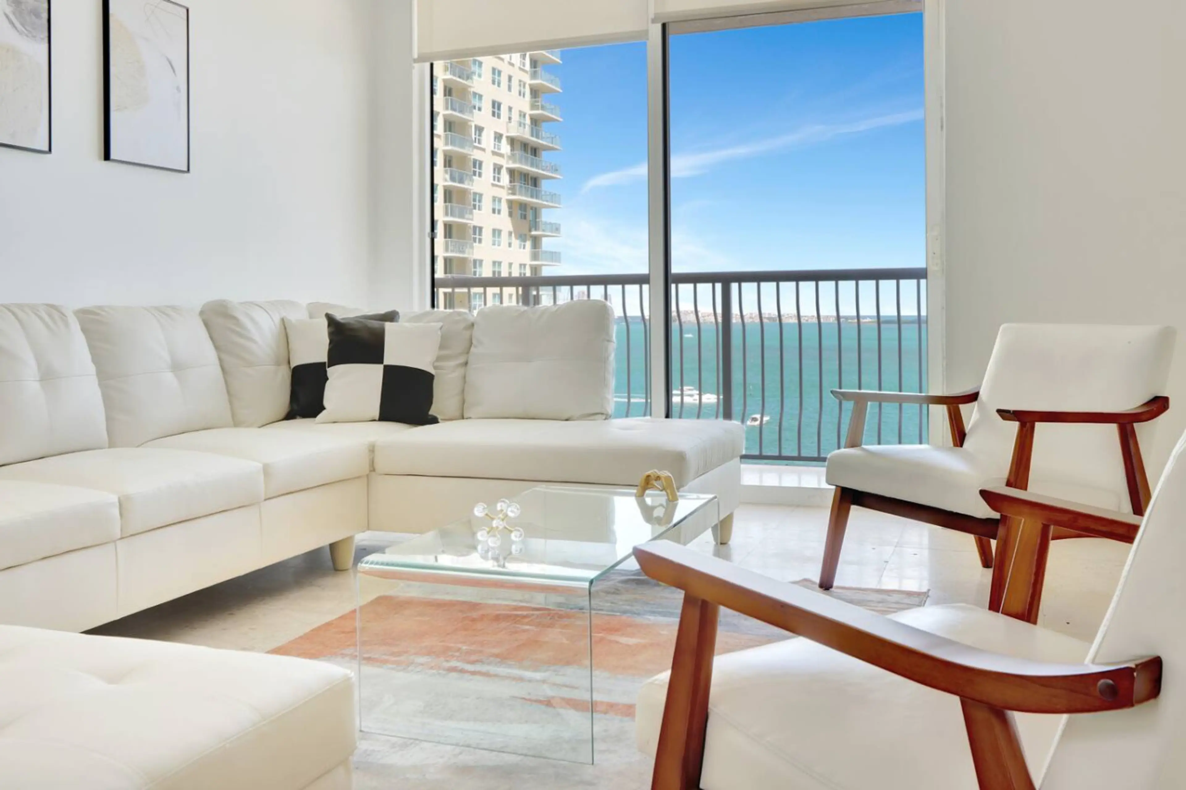 Pristine living room enriched with an abundance of natural light from floor to ceiling window!