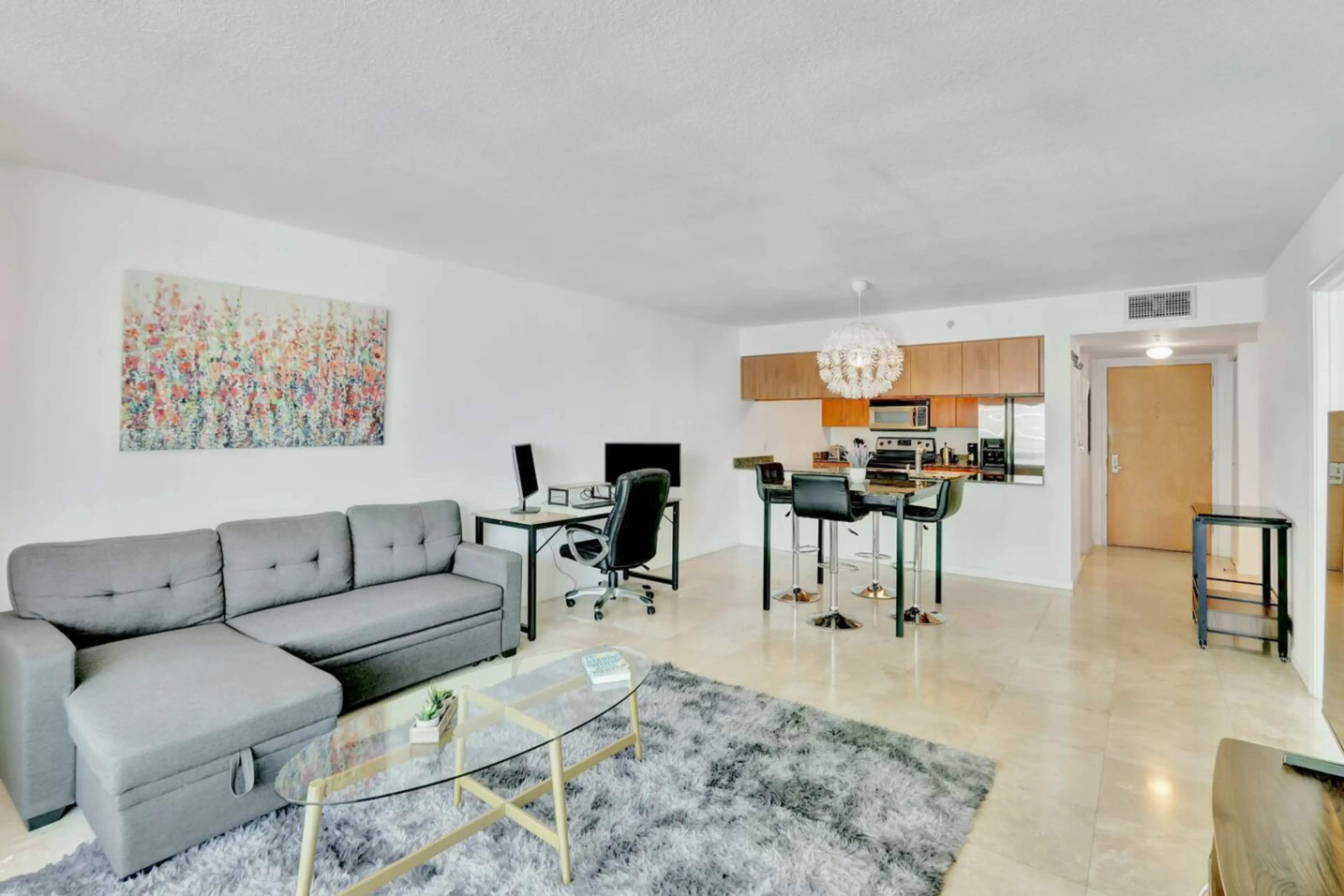 Spacious living area with cozy seating and smart TV - perfect for relaxing or streaming your favorites.