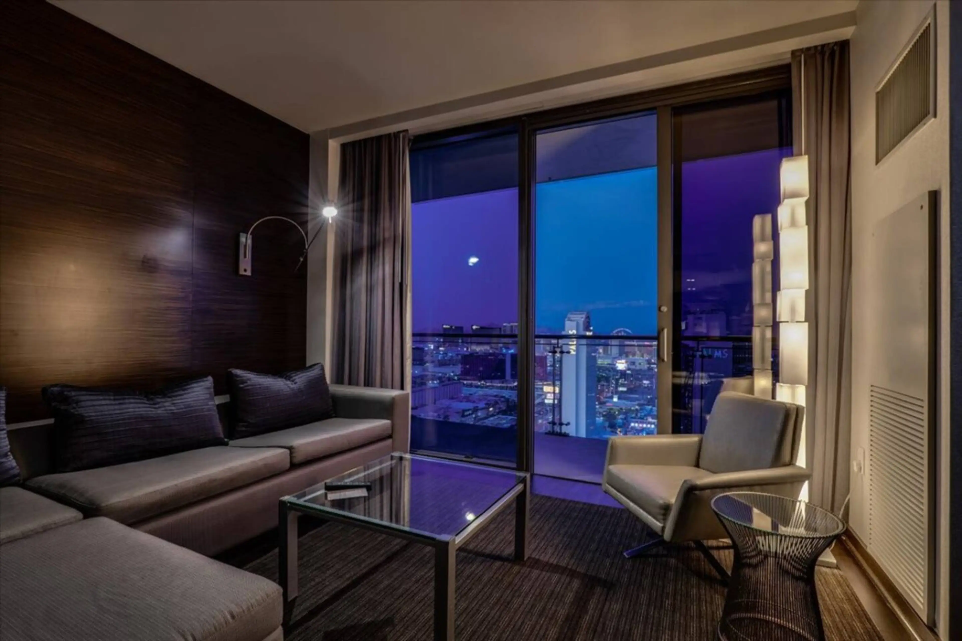 Relax and unwind in the cozy living area with plush seating, smart TV, and stunning city views.