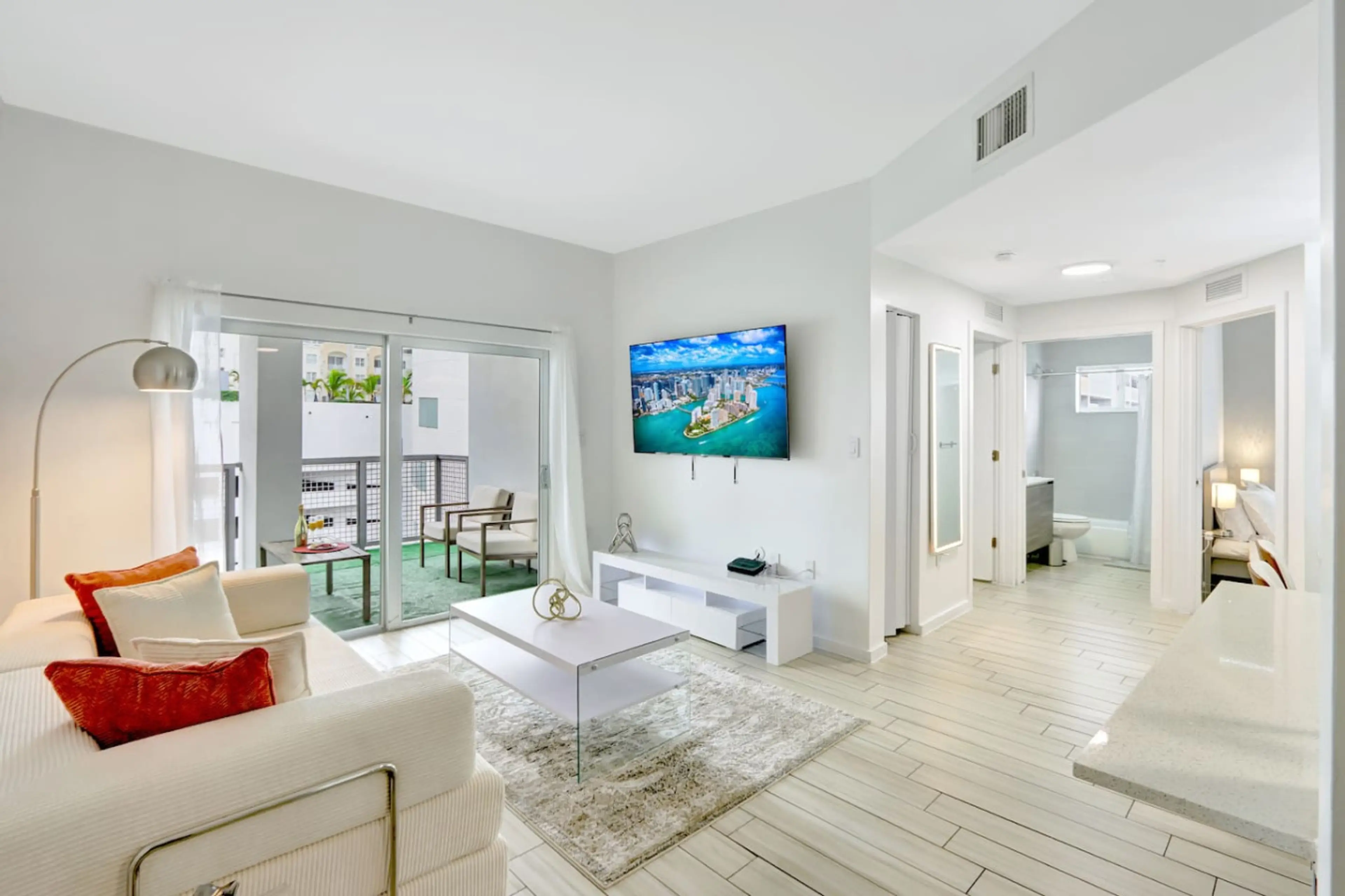 Spacious living room with cozy seating and a 65" smart TV, perfect for movie nights or relaxing after a day out.