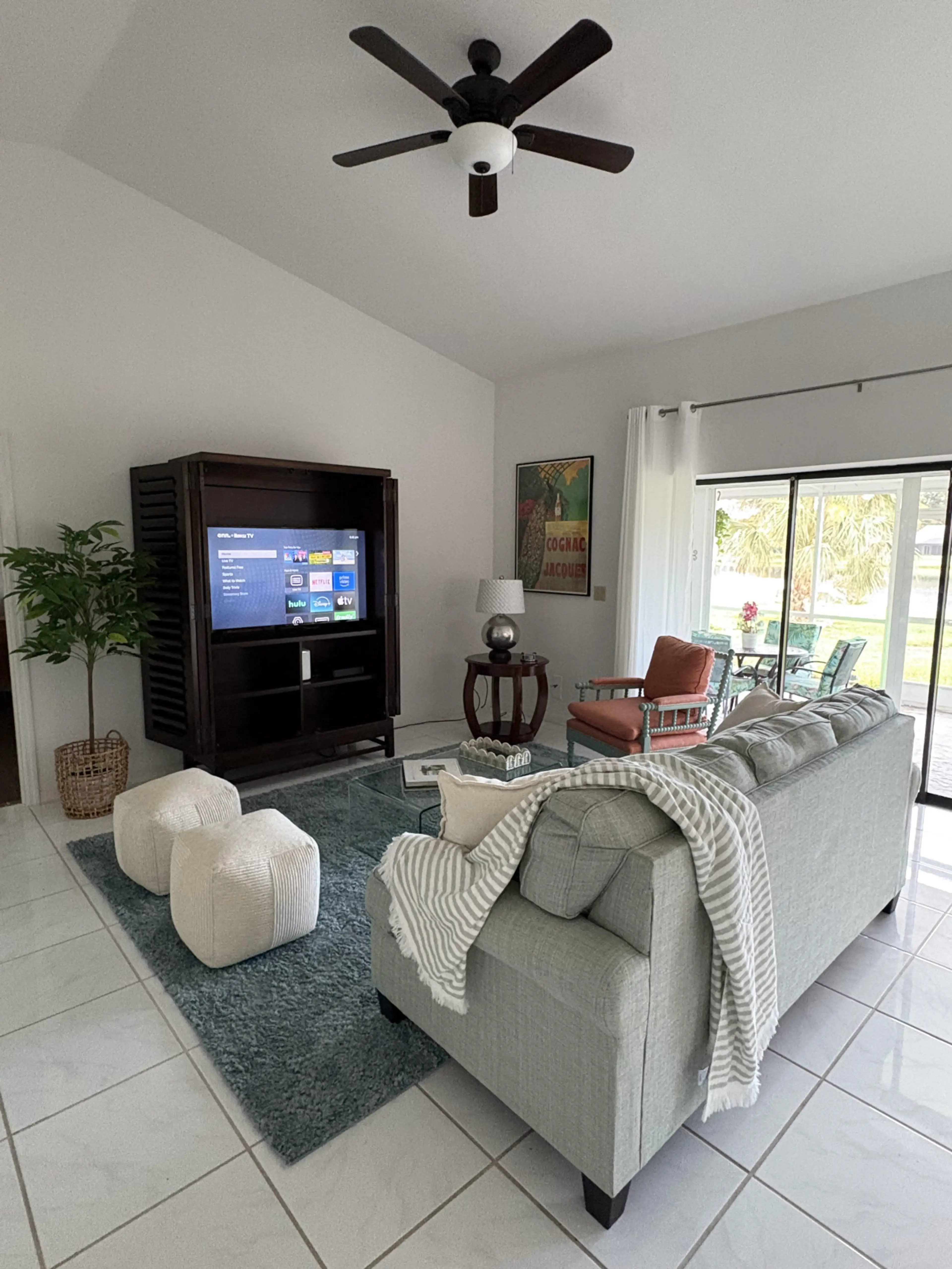 Relax in the spacious living room with plush seating, perfect for gatherings or quiet moments.