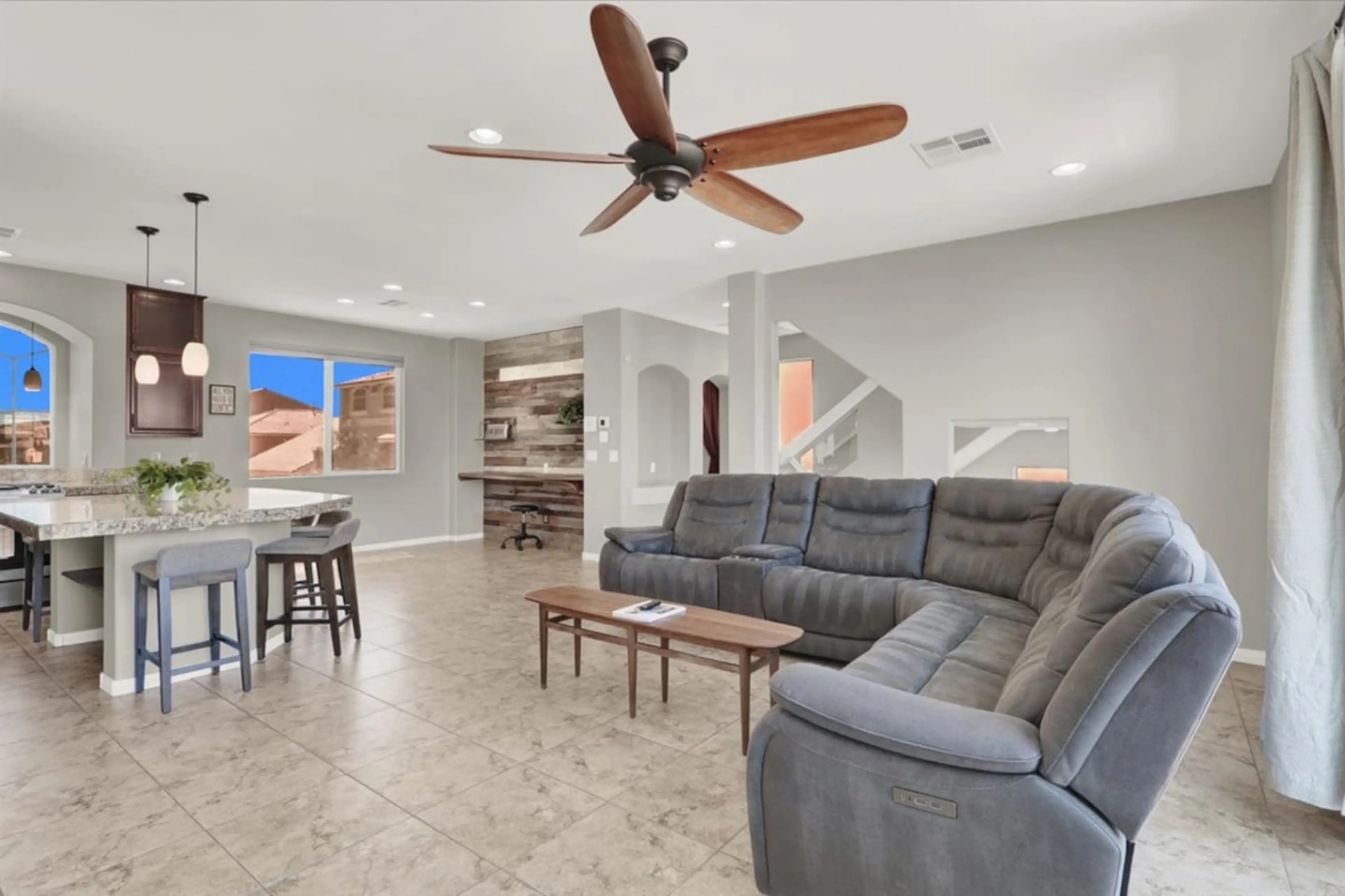 Spacious living room with plush seating and a 60” smart TV, perfect for family movie nights.