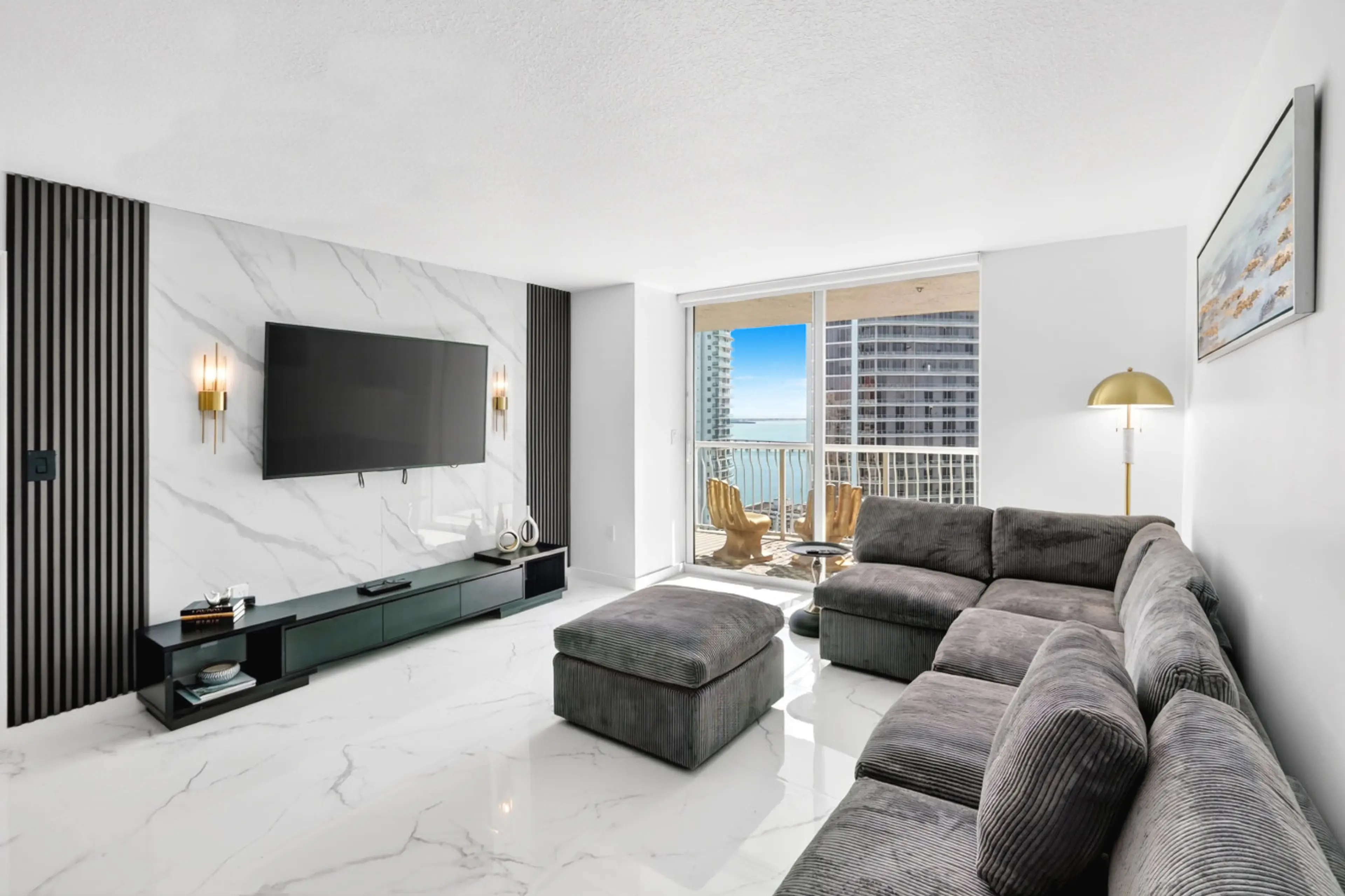 Bright and modern living room with comfortable seating and Smart TV.