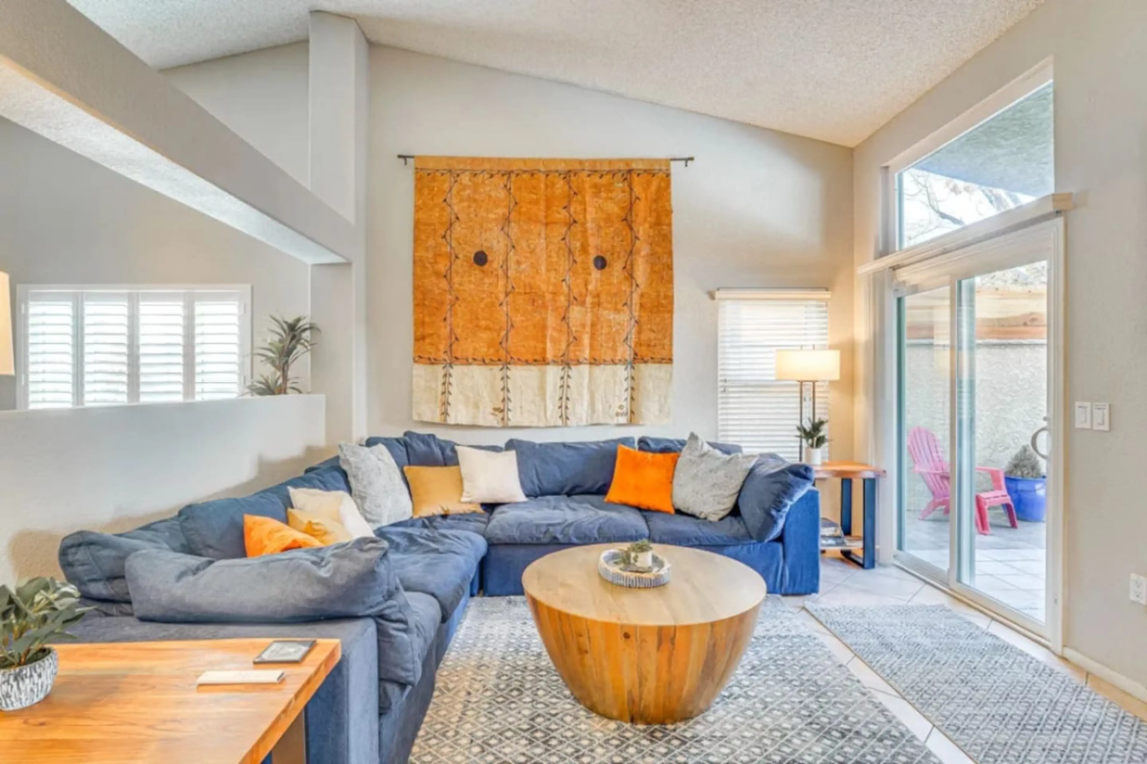 Bright and spacious living room with comfy seating and a 55” Smart TV.