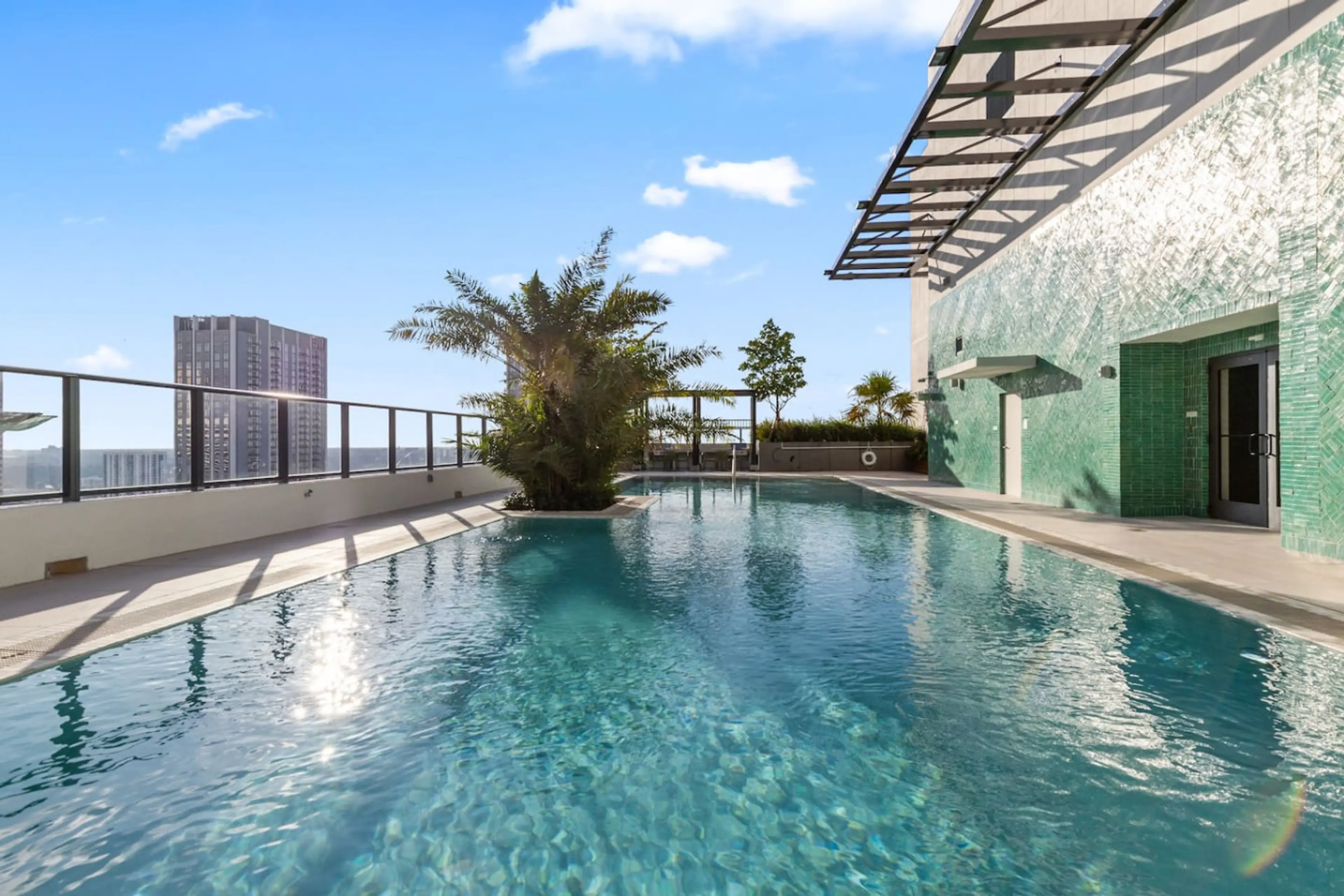 Resort-style amenities including rooftop pool & jacuzzi, cabanas, BBQ area, gym, sauna, coworking spaces, theater, gaming lounge, café, and 24/7 security