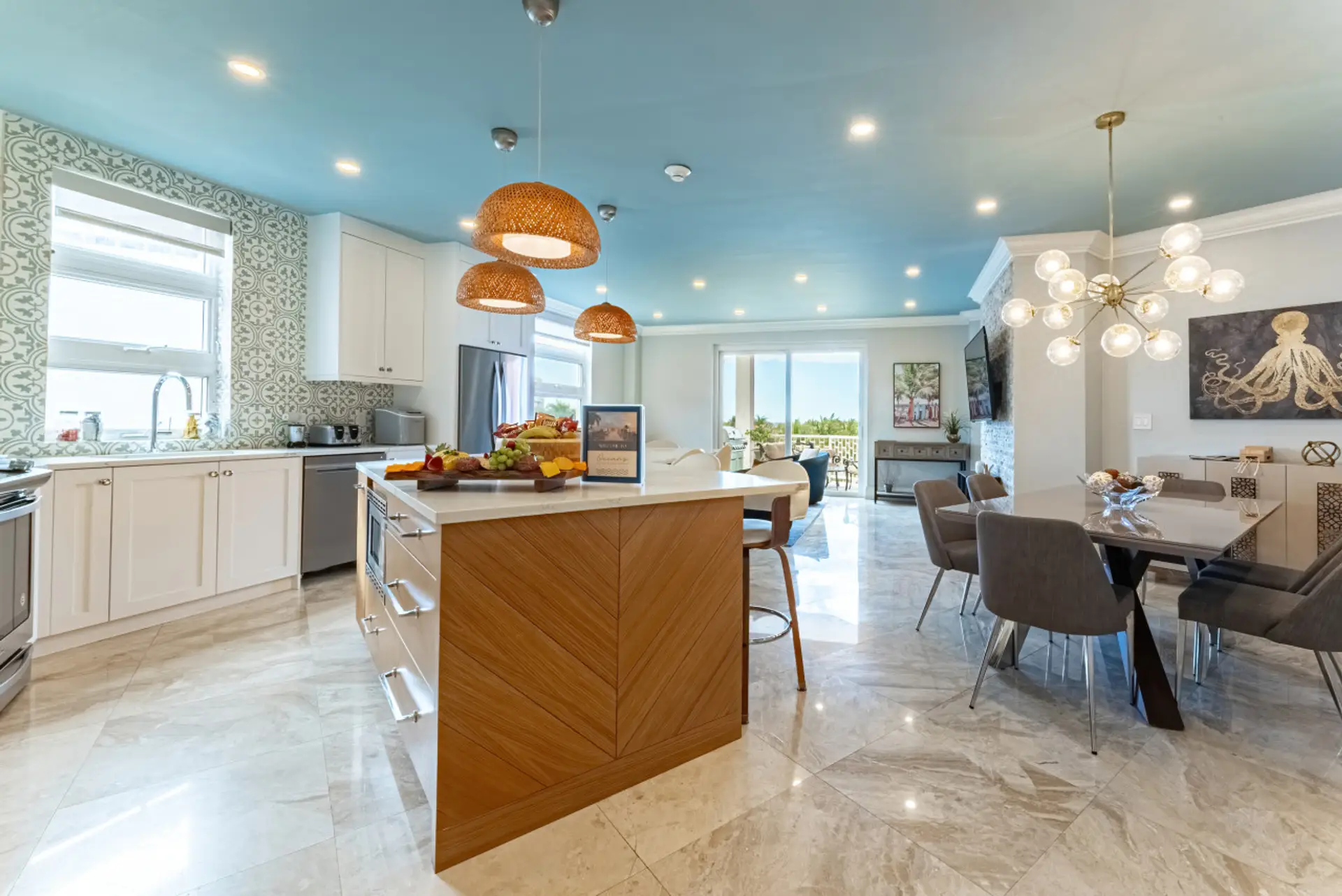 Open concept kitchen, living and dining room w/ beautiful ocean view from walk-out patio