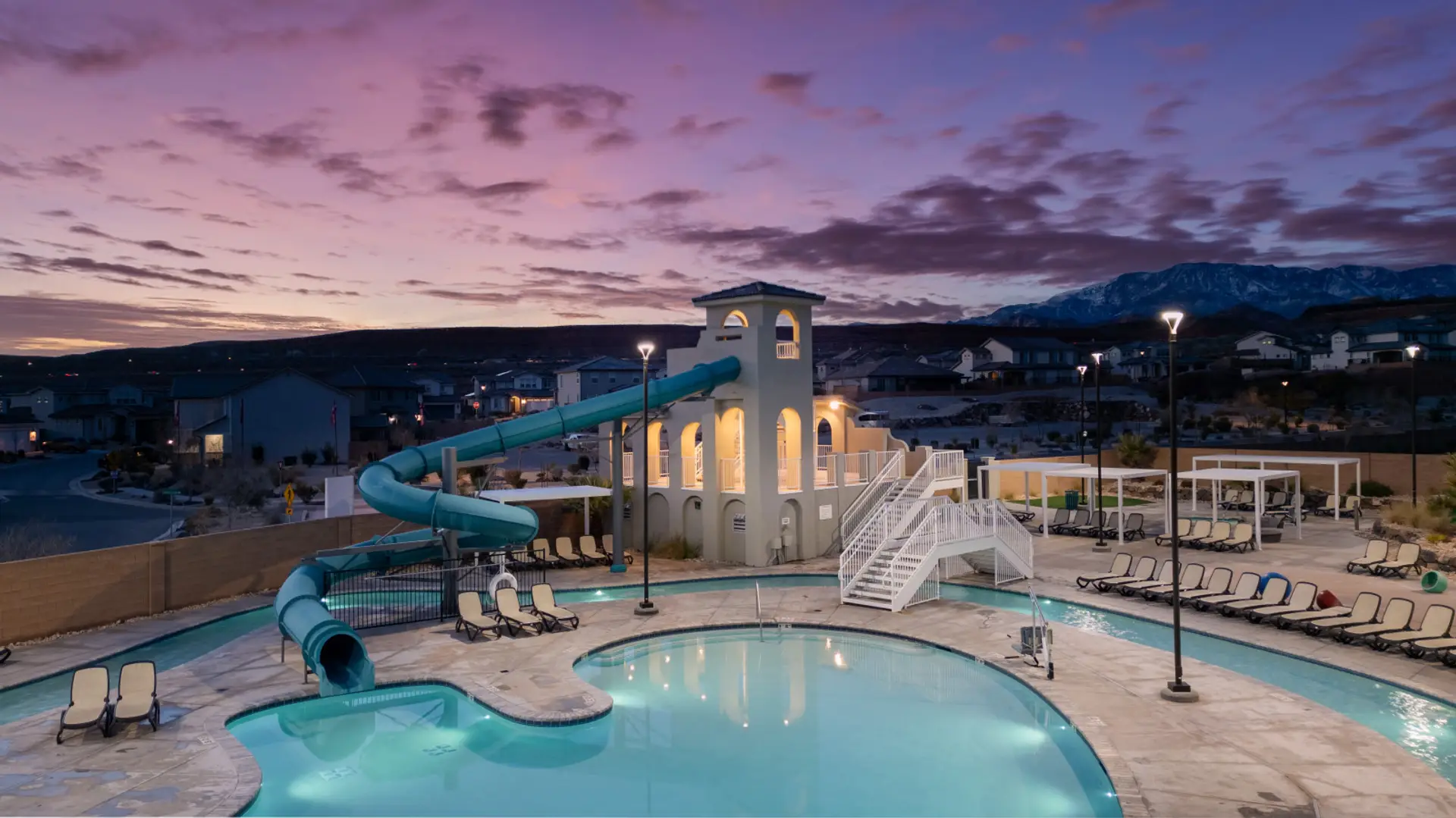 Poolside Paradise: Splash into fun with a water slide and stunning mountain views at sunset!