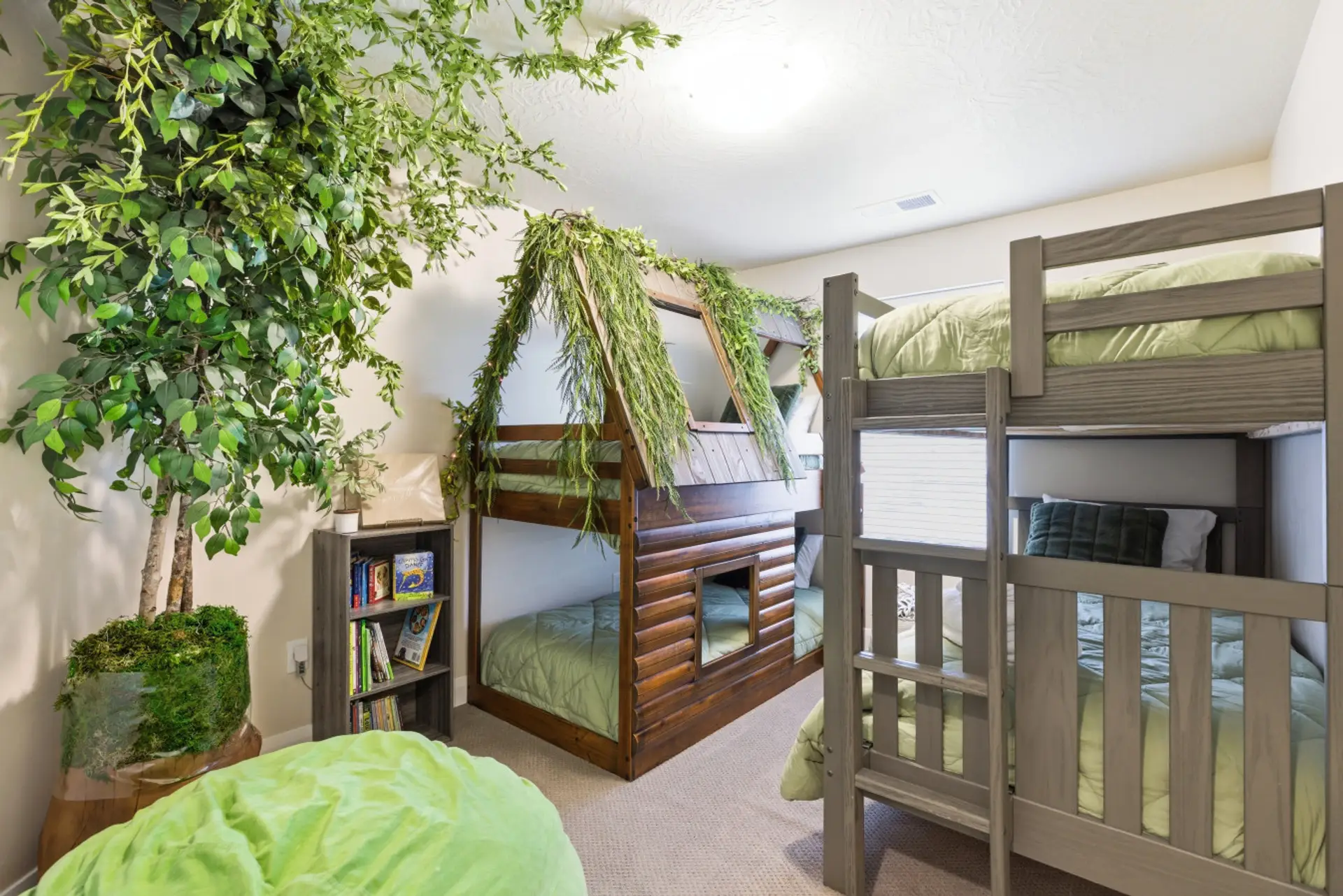 Bunk Room Bliss: Adventure awaits in this fun haven with whimsical treehouse themed beds and a tree!