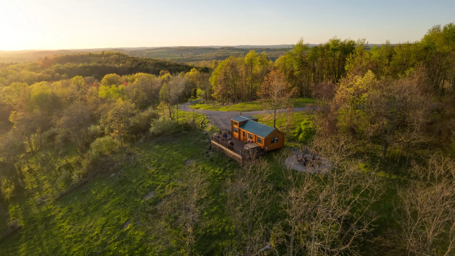 Secluded cabin surrounded by rolling hills and forest