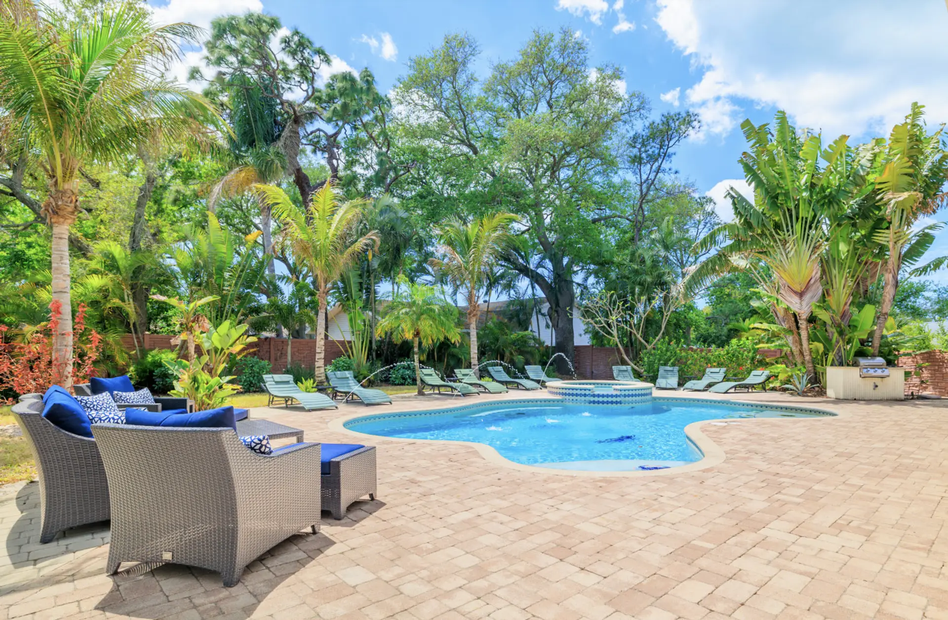 Garden style pool area with group seating, lounge chairs for 10 and BBQ area