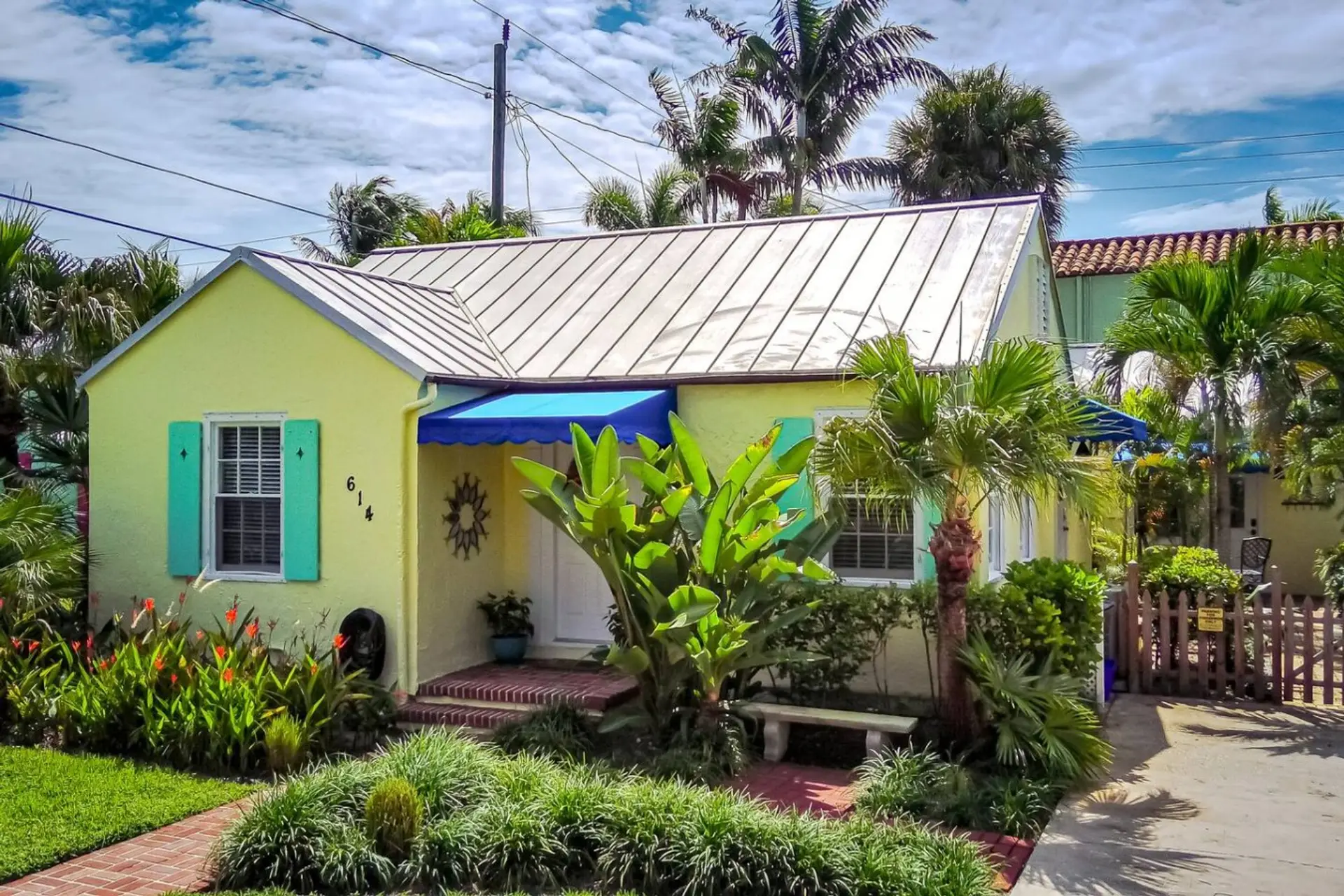 Key West Cottage in West Palm Beach, with a private entrance and tropical landscaping.